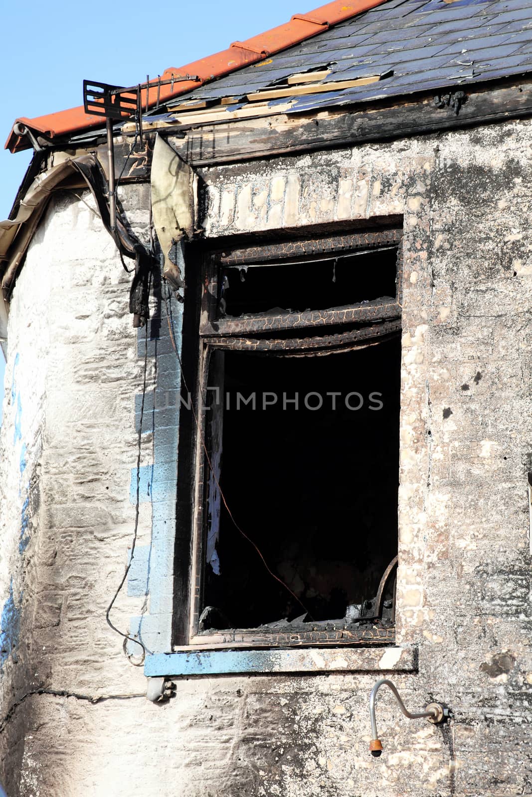 Burnt remains of a house property after an accidental house fire stock photo