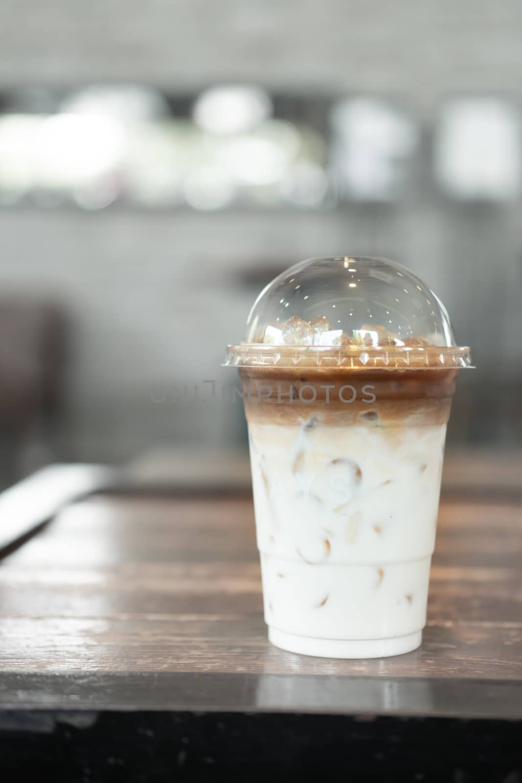 Ice coffee on table with film vintage tone background.