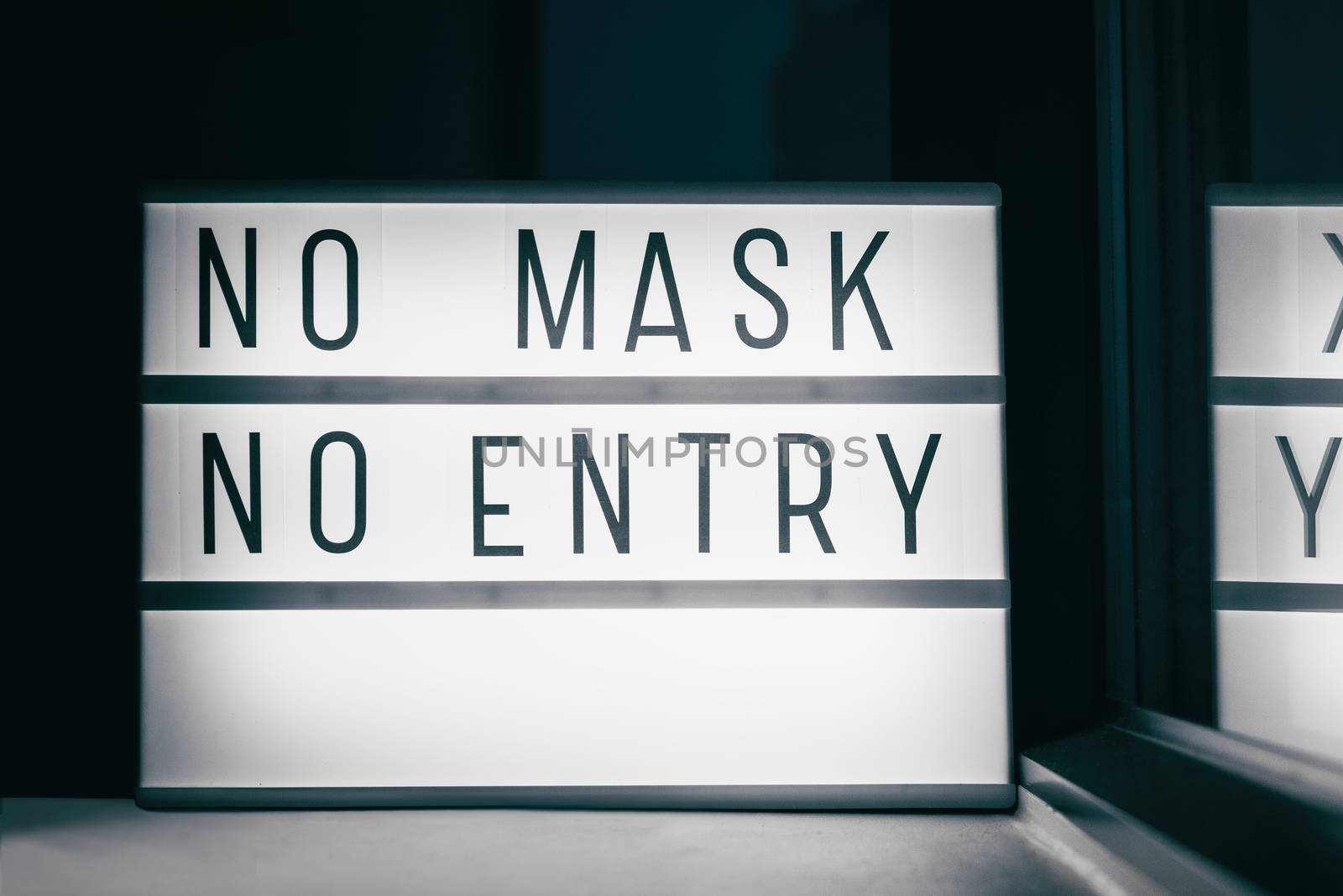 Covid-19 mask obligatory to enter stores . SIGN NO MASK NO ENTRY at storefront window. Face covering wearing mandatory when shopping outside of home. Coronavirus prevention measure by Maridav