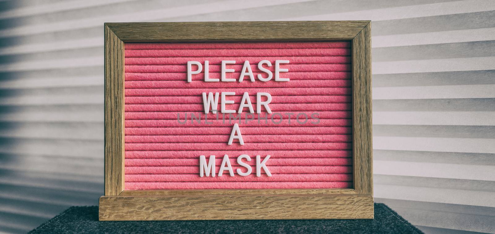 Please wear a mask pink sign at business store entrance message. Obligatory wearing of COVID-19 protection face cover by Maridav