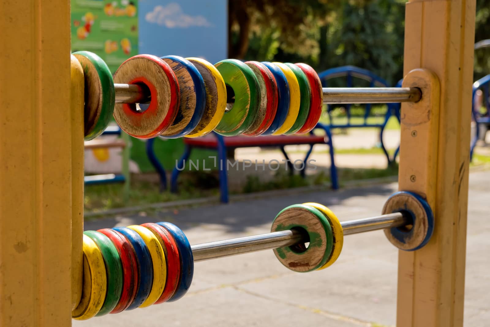 Large colored children's abacus, wooden rings. Closeup.