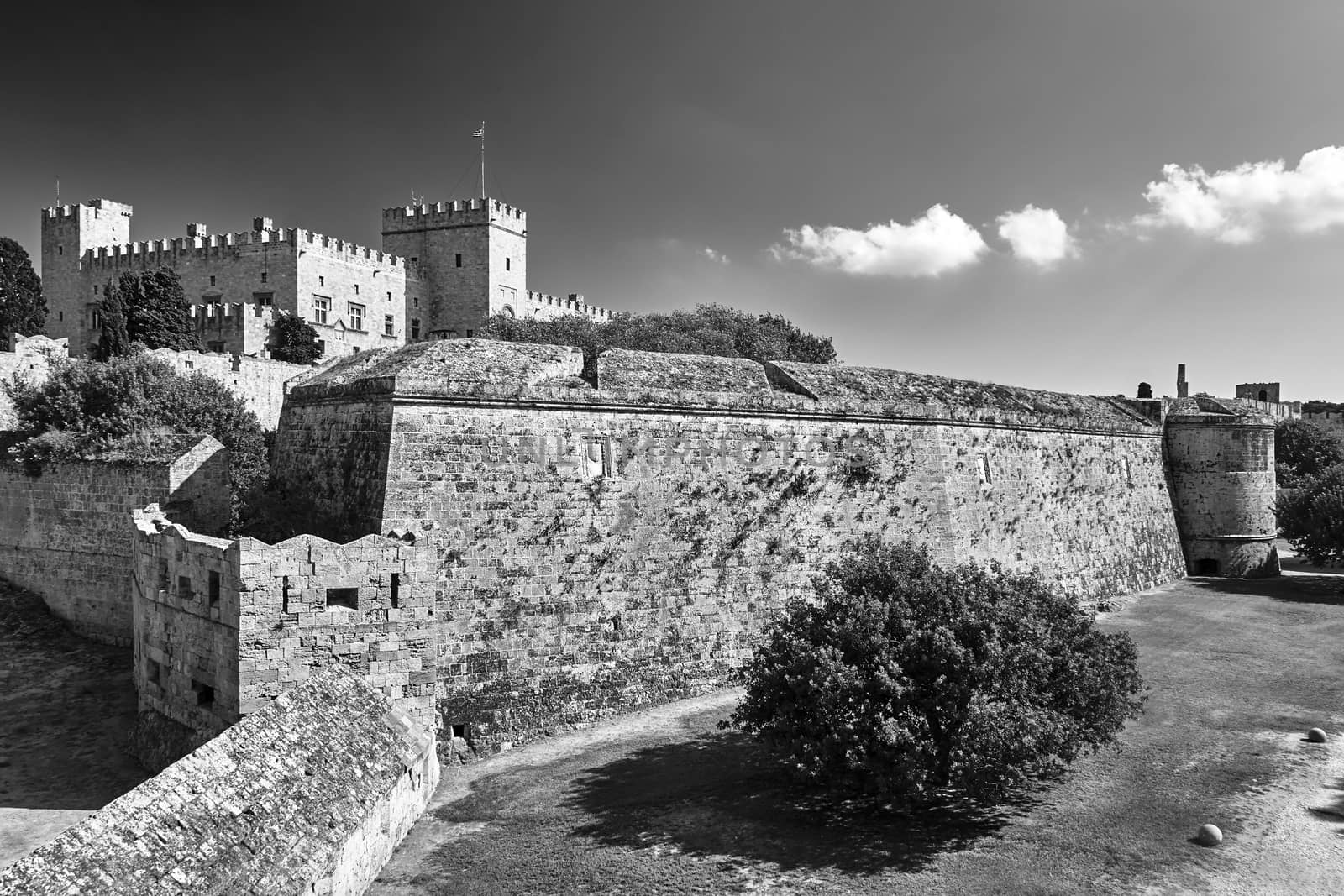 The walls and turrets of the medieval castle of the Joannite Order in the city of Rhodes, black and white