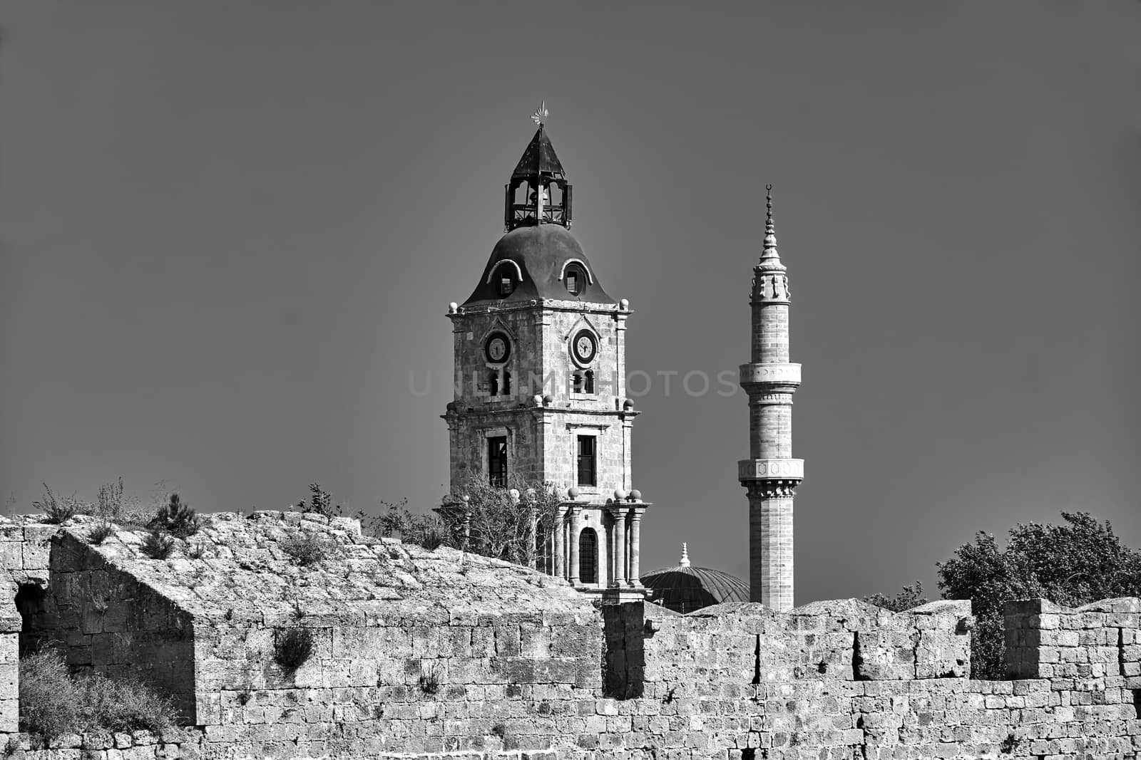 Stone Tower and Turkish minaret behind the medieval defensive wall in Rhodes, black and white