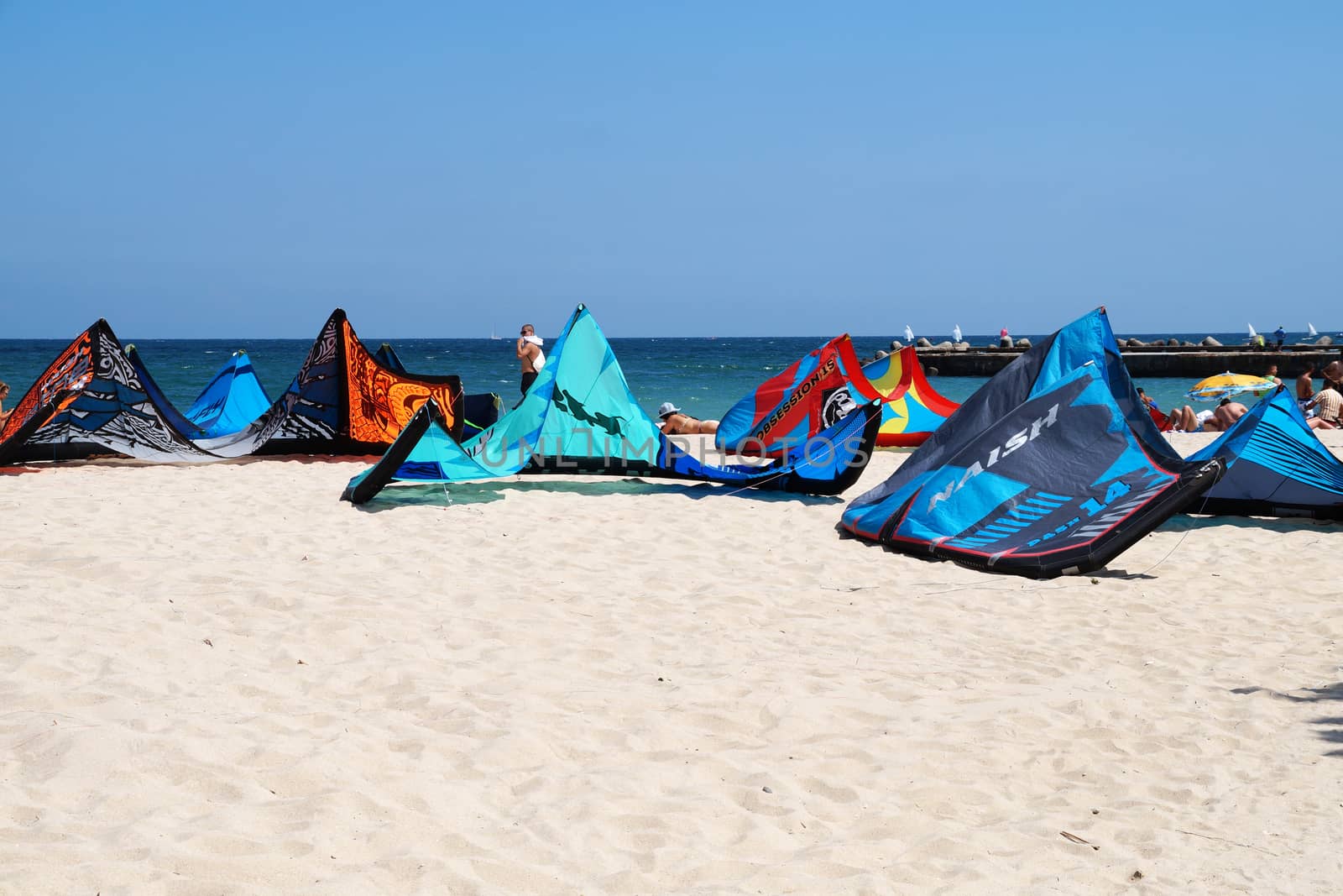 Varna, Bulgaria - July, 19, 2020: multi-colored parachutes for kiting on the sandy beach