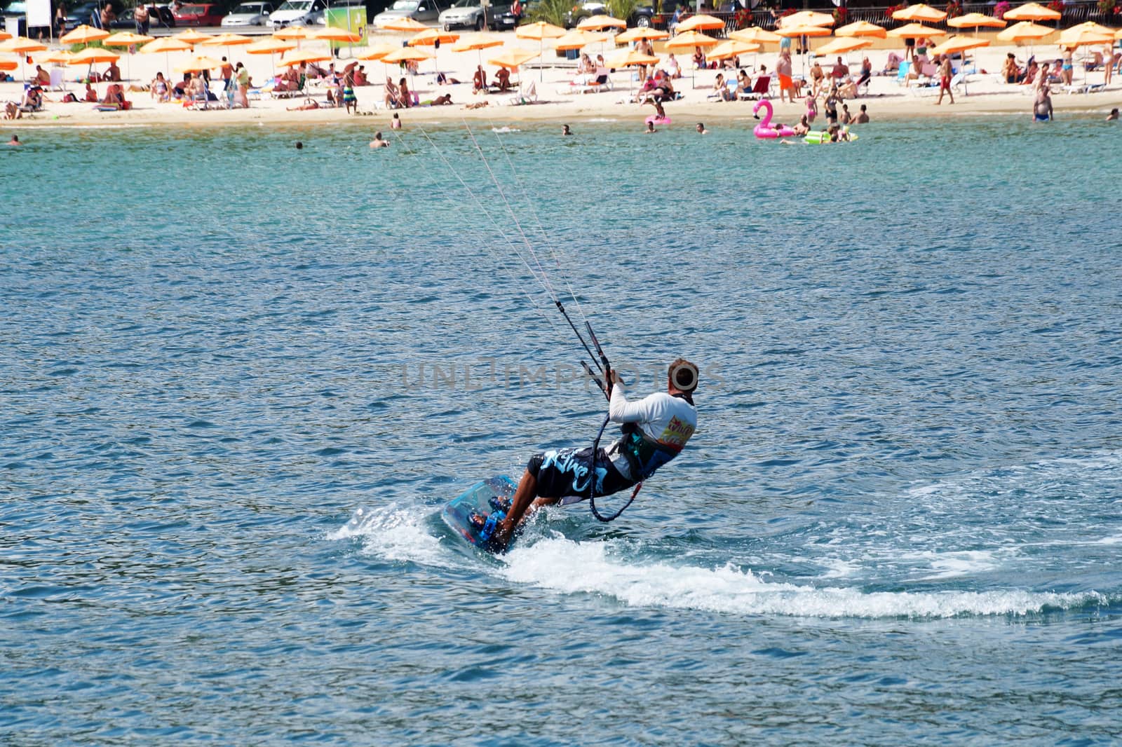 Varna, Bulgaria - July, 19, 2020: a man is kiting the sea against the background of the beach