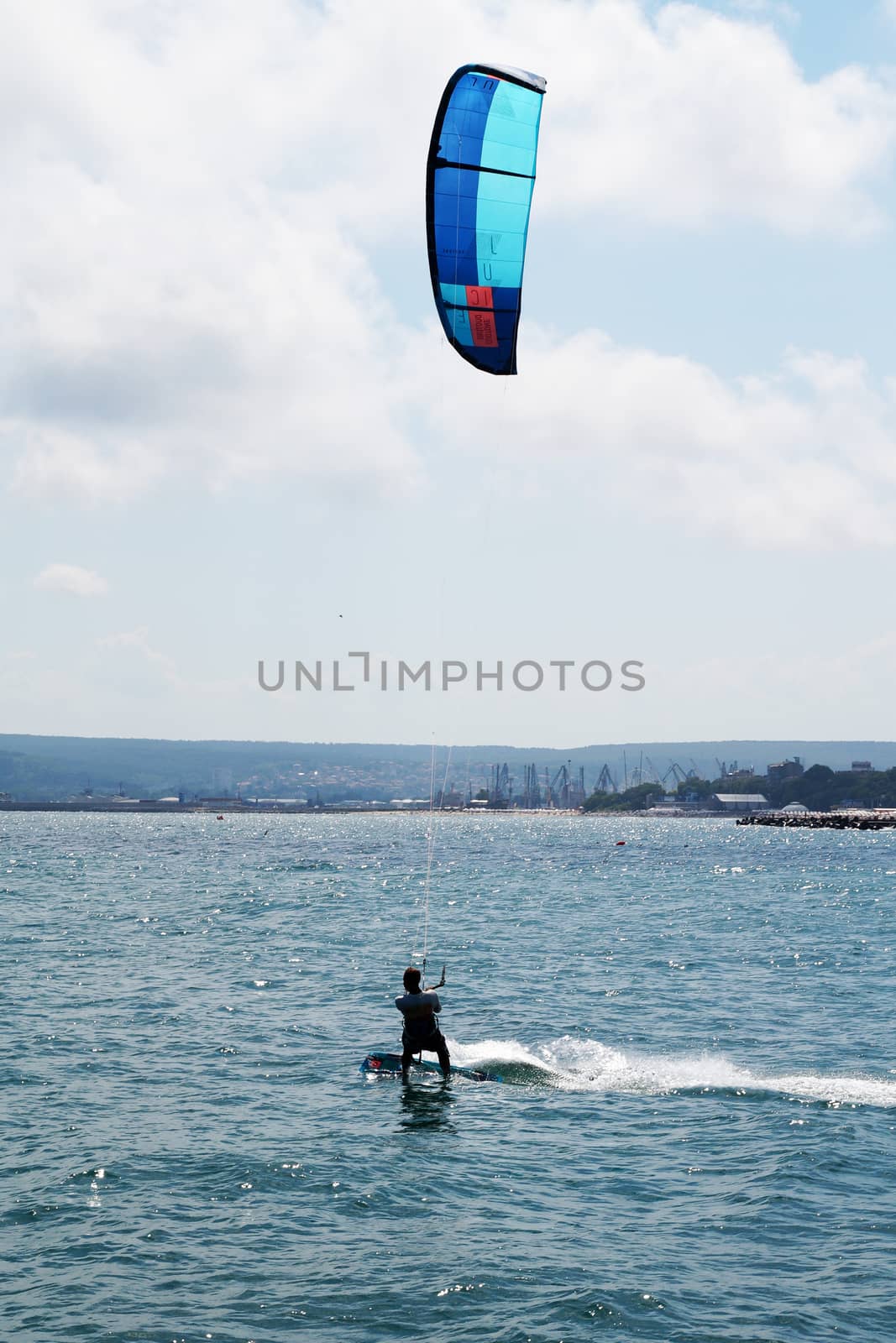 Varna, Bulgaria - July, 19, 2020: a man is kiting the sea against the background of the beach