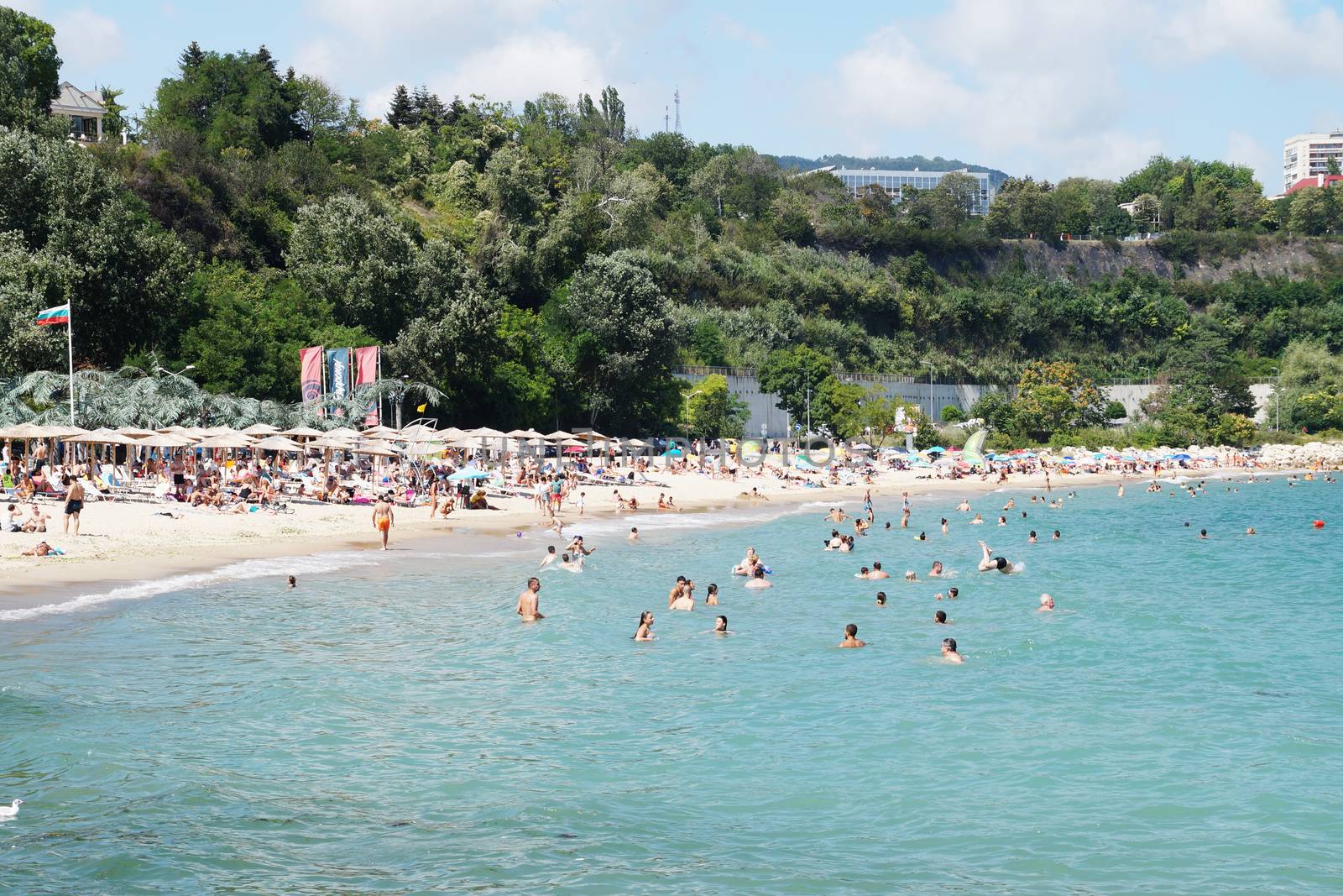 Varna, Bulgaria - July, 19, 2020: people sunbathe and swim on the sea beach