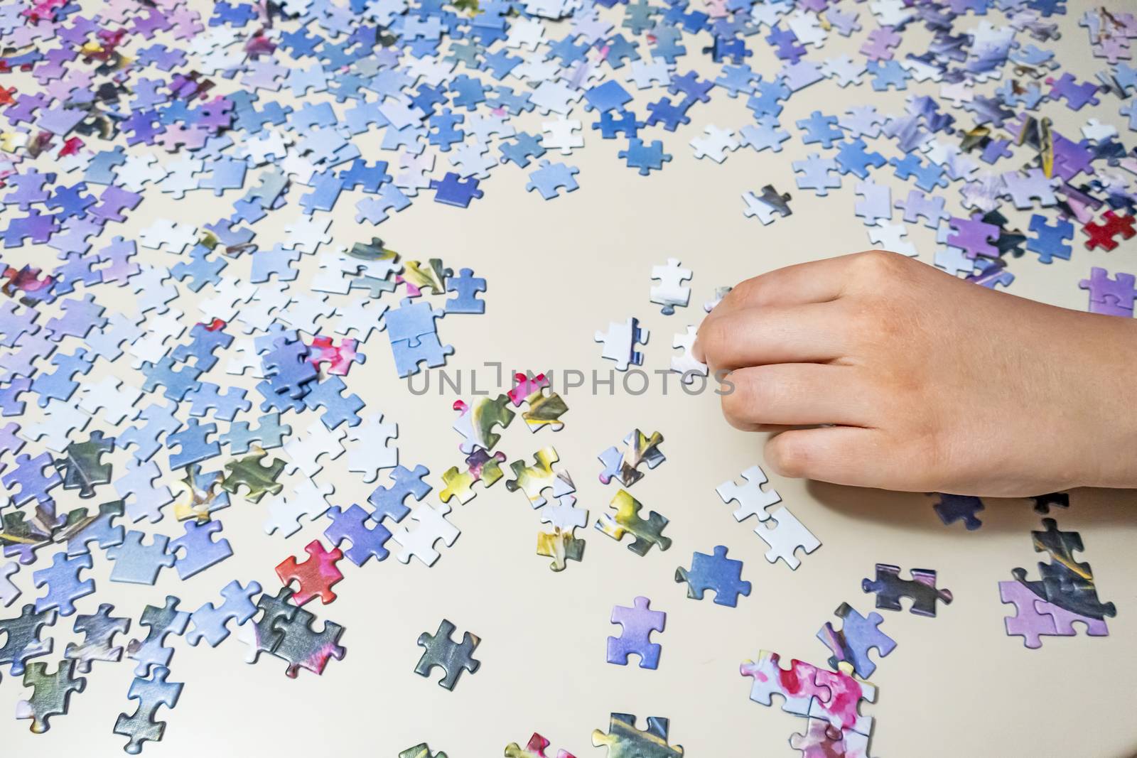 close up hands holding puzzle pieces