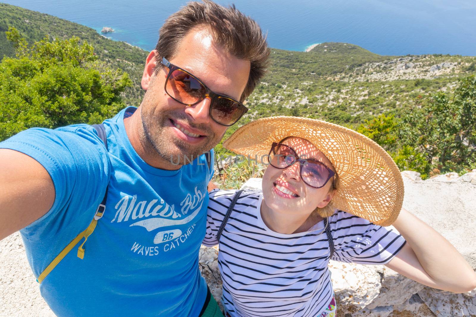 Beautiful, romantic caucasian couple taking selfie self portrait photo on summer vacations on Adriatic coast of Croatia.