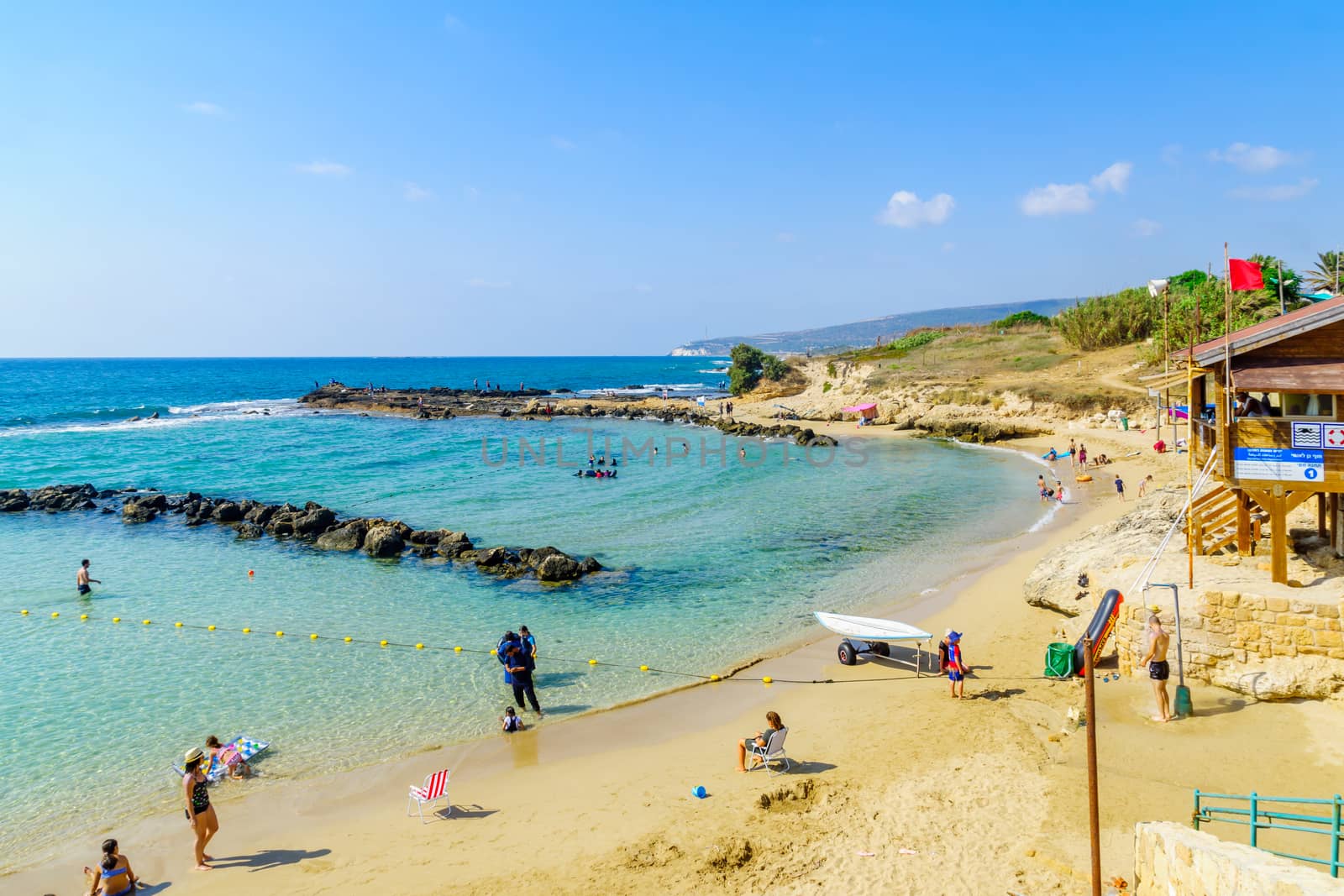 Achziv, Israel - July 22, 2020: View of a bay on the coast, with visitors, in Achziv national park, northern Israel