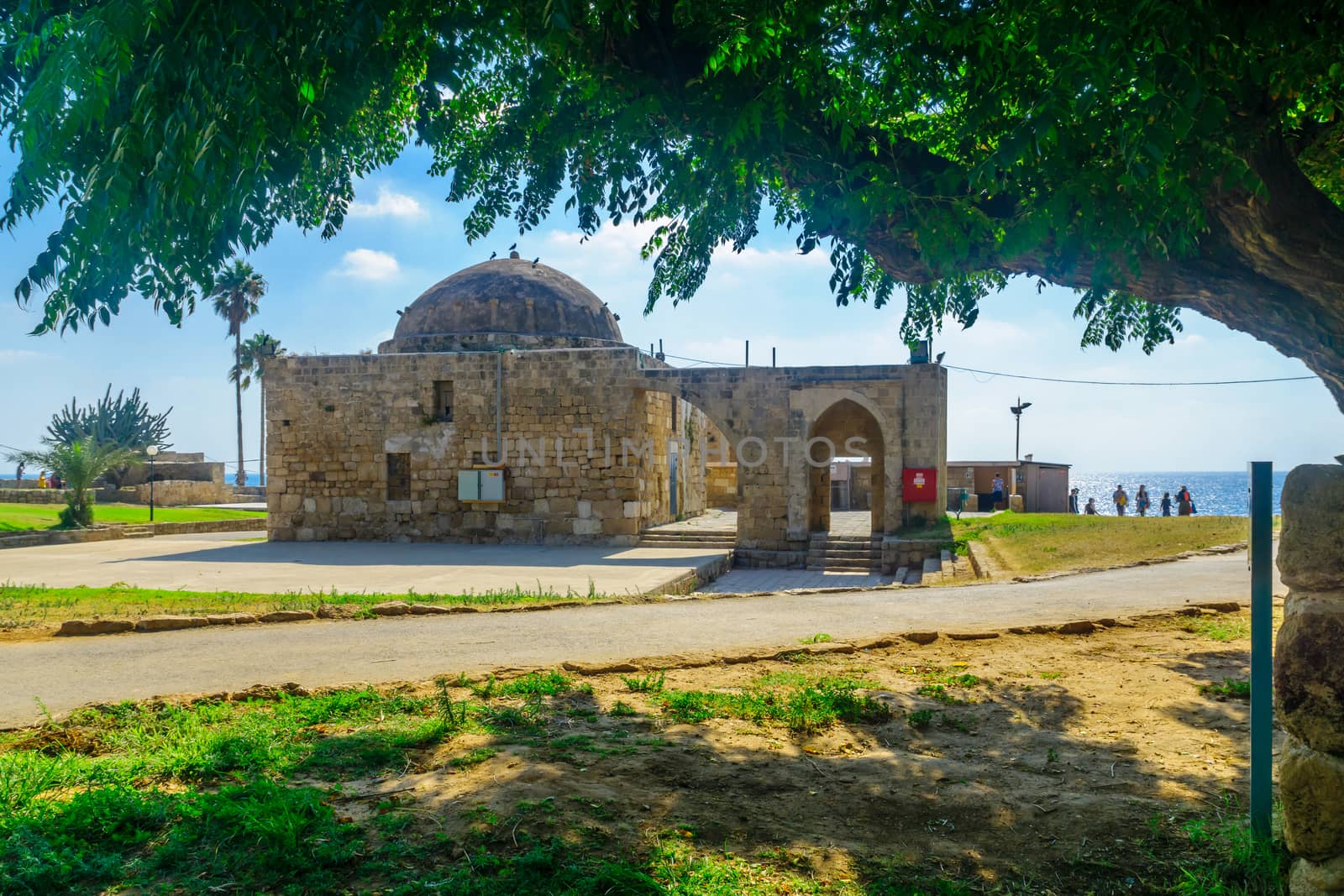 Achziv, Israel - July 22, 2020: View of an old mosque building, with visitors, in Achziv national park, northern Israel