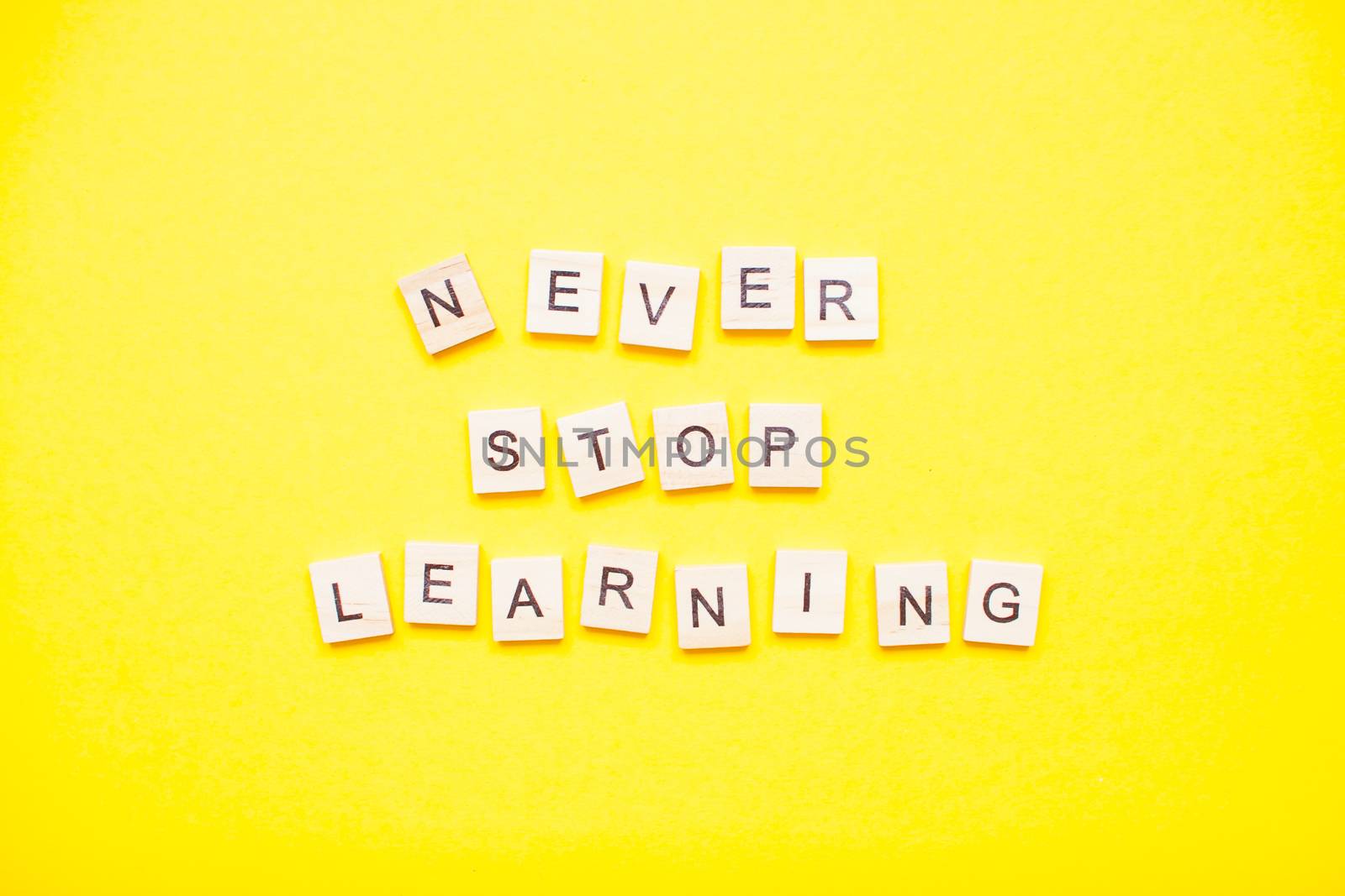 Words from wooden blocks "never stop learning" by malyshkamju