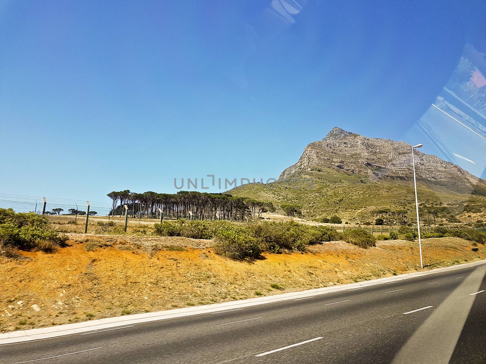 Drive by Mountains, Cape Town. Watch out of car window. by Arkadij