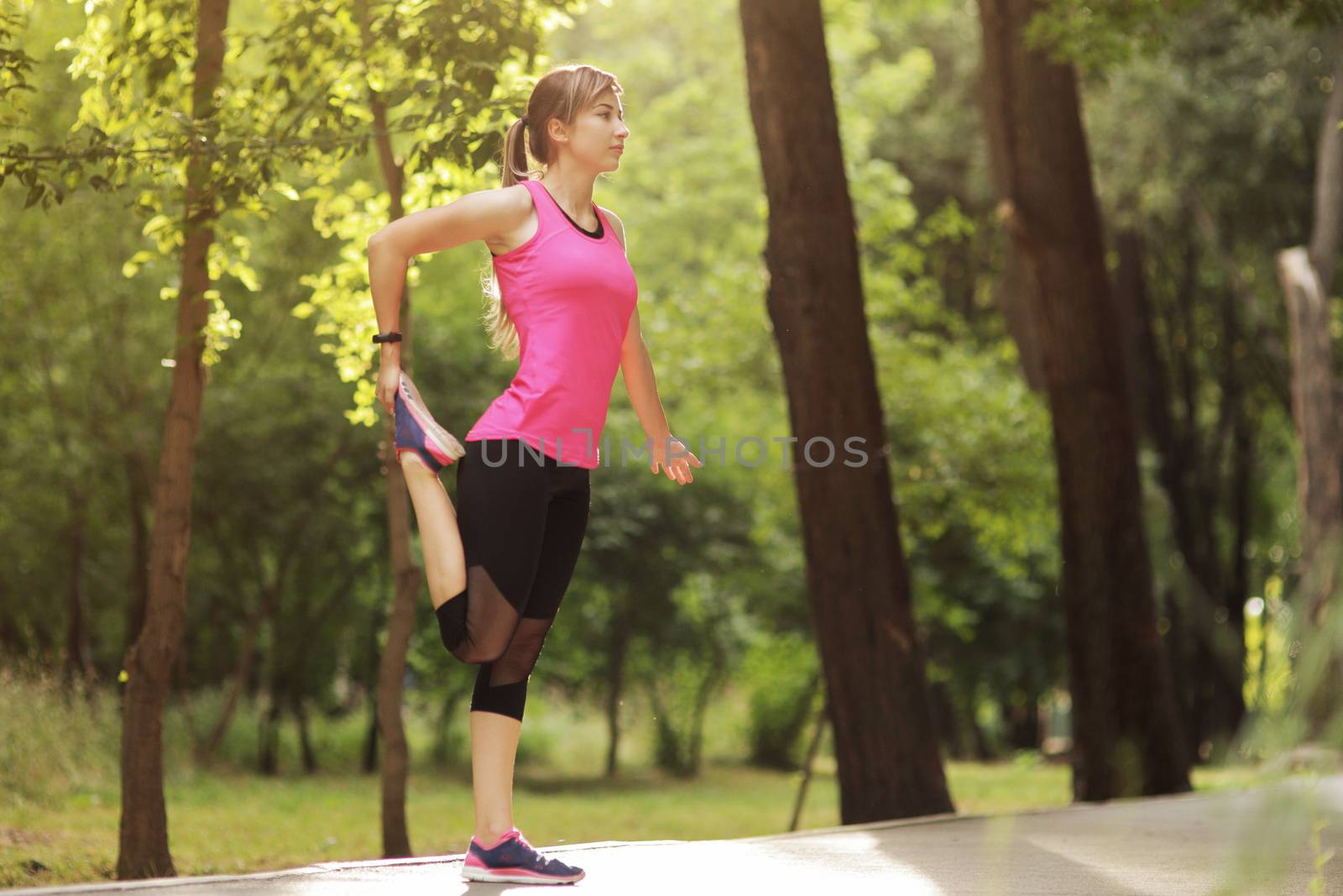 The young woman is engaged in sports fitness in nature forest Healthy fit living. Motivation healthy fit living. Running shoe. Beautiful sunlight. Woman warming up before running