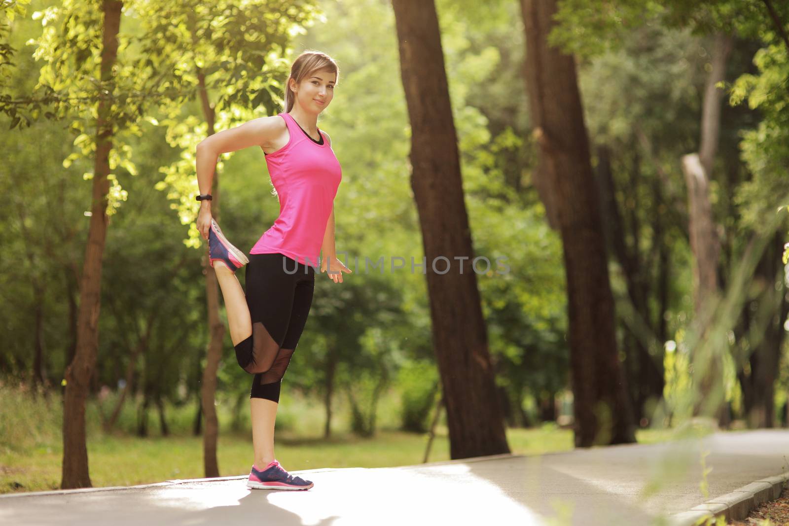 The young woman is engaged in sports fitness in nature forest Healthy fit living. Motivation healthy fit living. Running shoe. Beautiful sunlight. Woman warming up before running