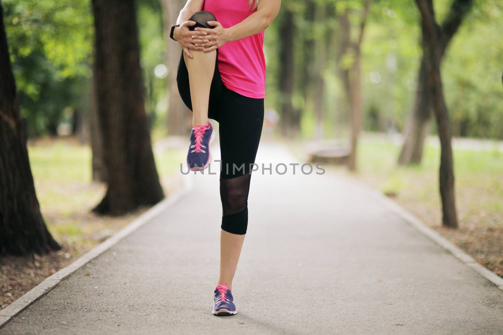 The young woman is engaged in sports fitness in nature forest Healthy fit living by selinsmo