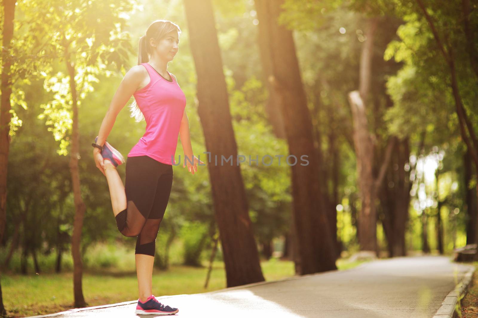 The young woman is engaged in sports fitness in nature forest Healthy fit living. Motivation healthy fit living. Running shoe. Beautiful sunlight. Woman warming up before running
