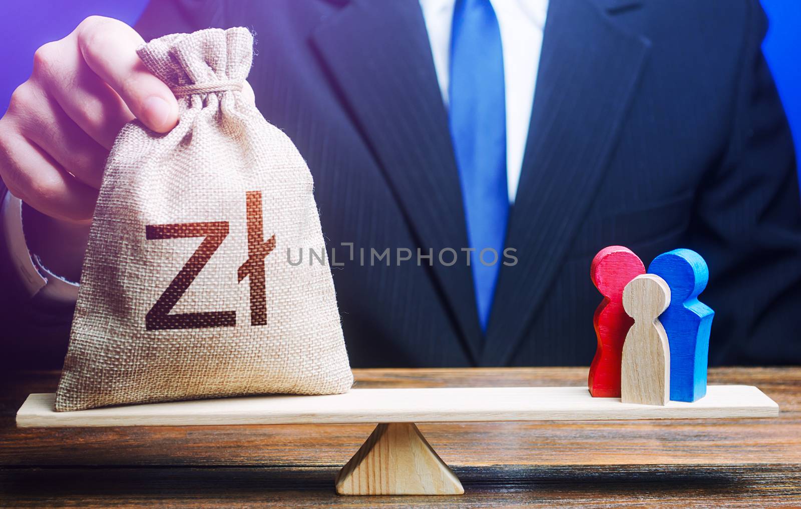 Man puts polish zloty money bag on scales with family figures. Social assistance benefits, financial support. Charitable donations. Investments in human capital, culture and social projects.