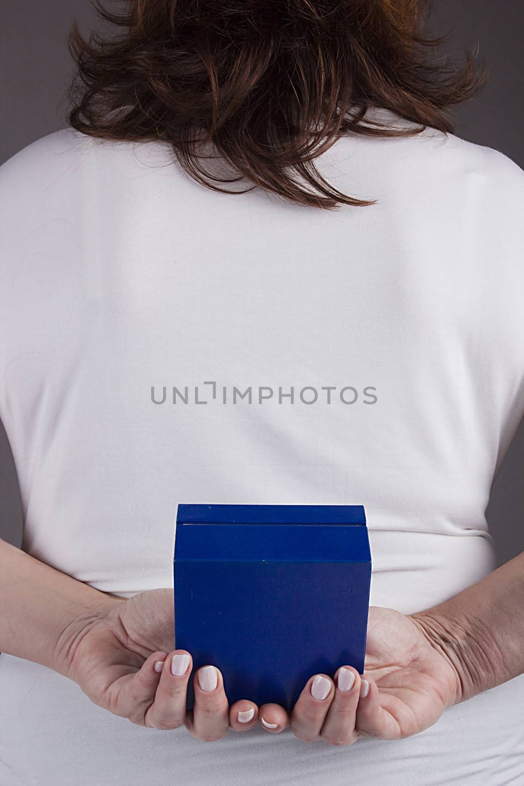 Woman with a gift behind her back by VIPDesignUSA