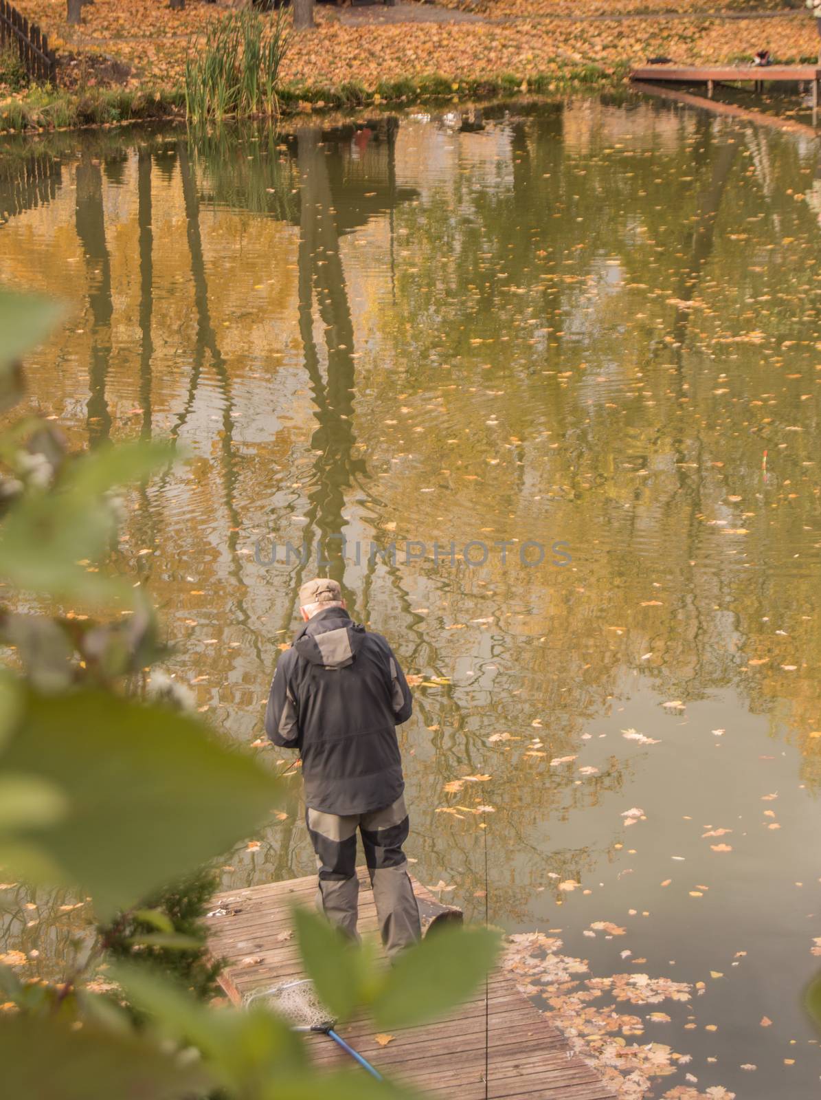 A male social worker ecologist watches the state of the water in the city pond, standing on the Bank. Environmental monitoring of the reservoir and the environment.