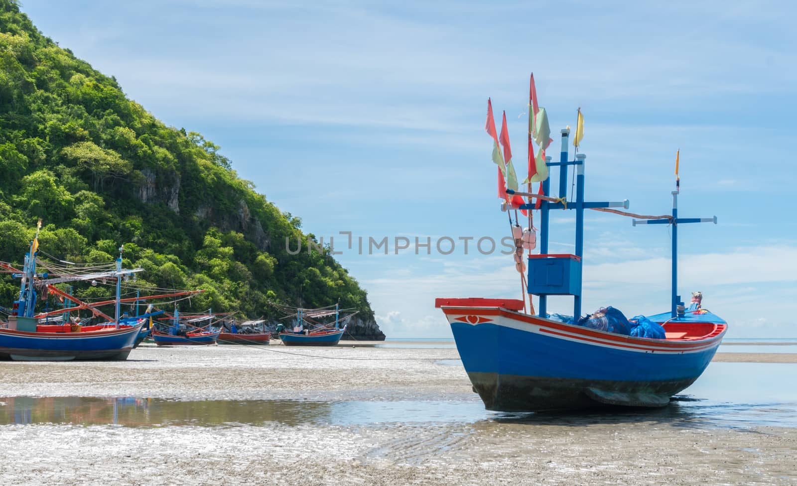 Blue Fishing Boat on Sea Sand with Green Mountain at Khao Kalok  by steafpong