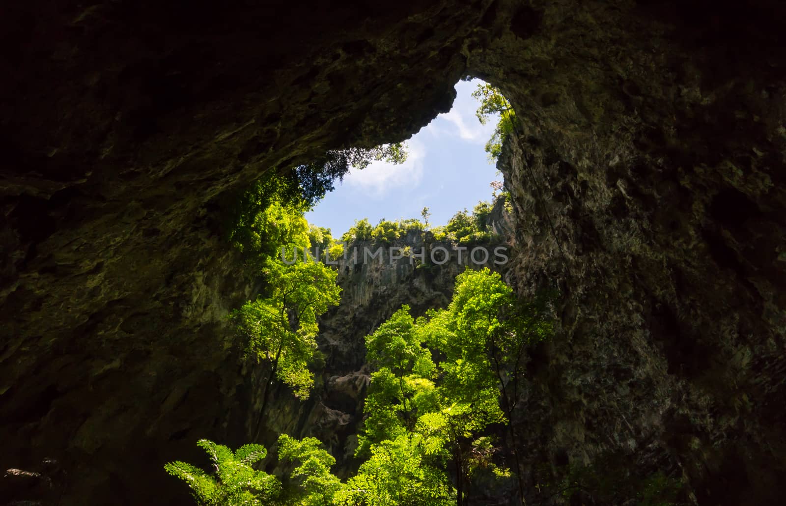 Sun light hole in Phraya Nakhon Cave with green tree and blue sky and cloud at Prachuap Khiri Khan Thailand. Natural cave in unseen Thailand