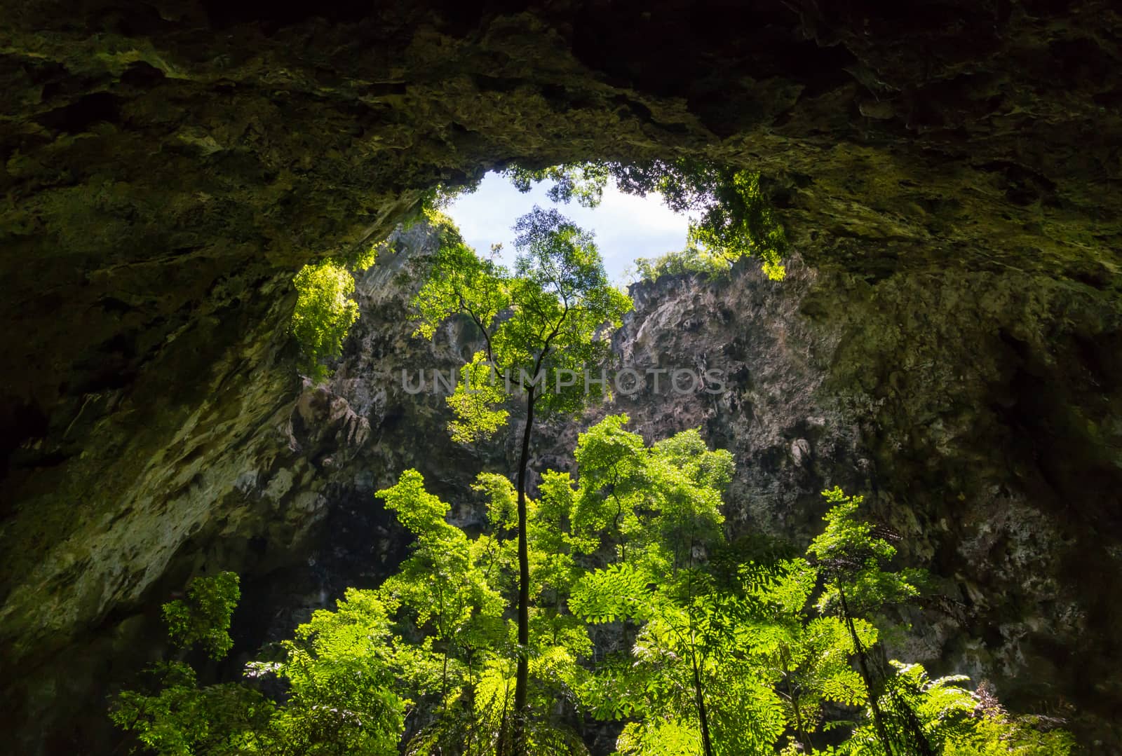 Sun light hole in Phraya Nakhon Cave with green tree and blue sky and cloud at Prachuap Khiri Khan Thailand. Natural cave in unseen Thailand