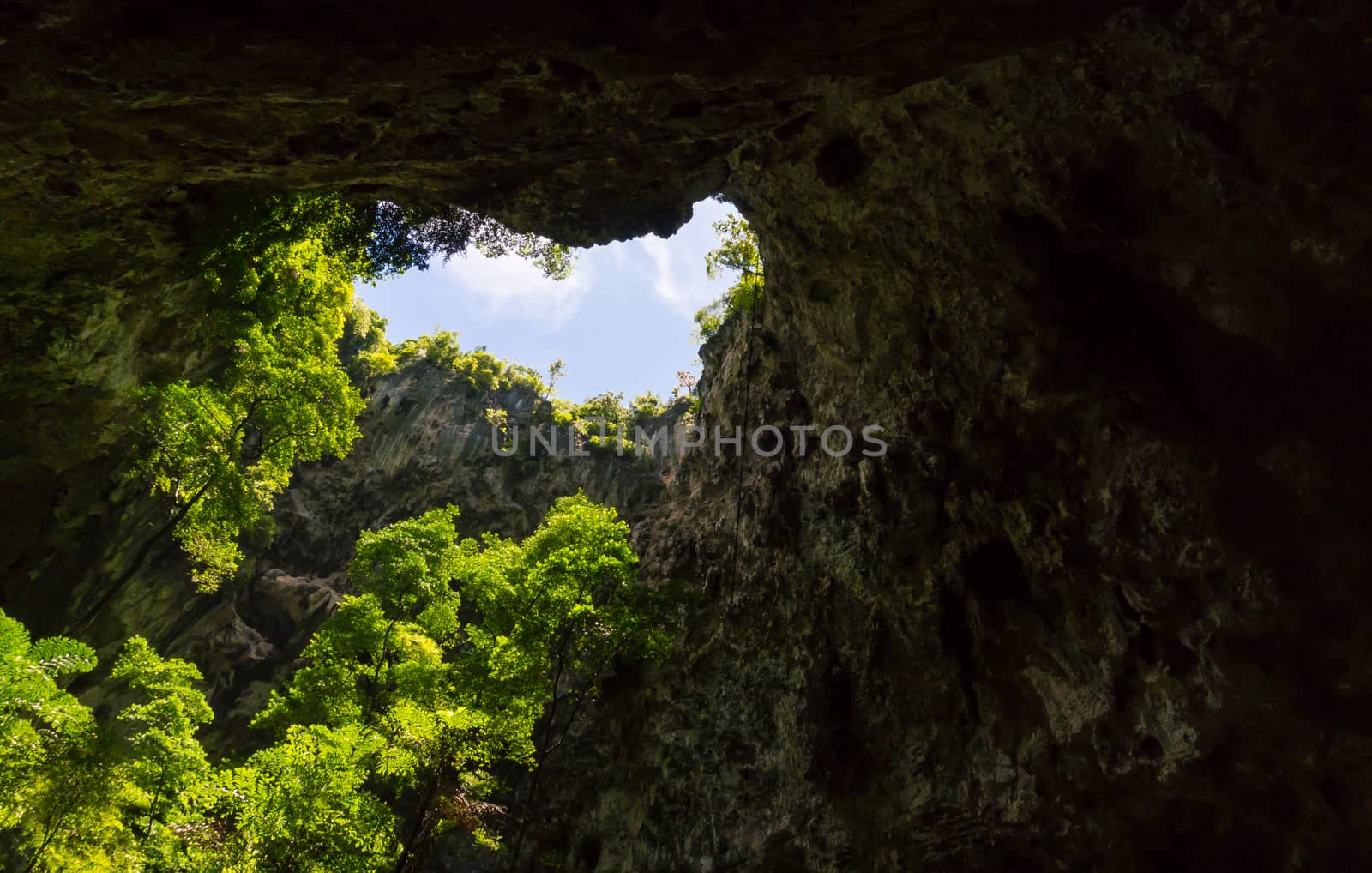 Sun light hole in Phraya Nakhon Cave with green tree and blue sky and cloud at Prachuap Khiri Khan Thailand. Natural cave in unseen Thailand