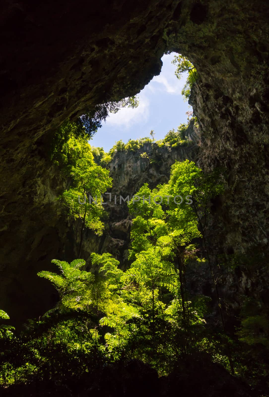 Sun light hole in Phraya Nakhon Cave with green tree and blue sky and cloud at Prachuap Khiri Khan Thailand. Natural cave in unseen Thailand