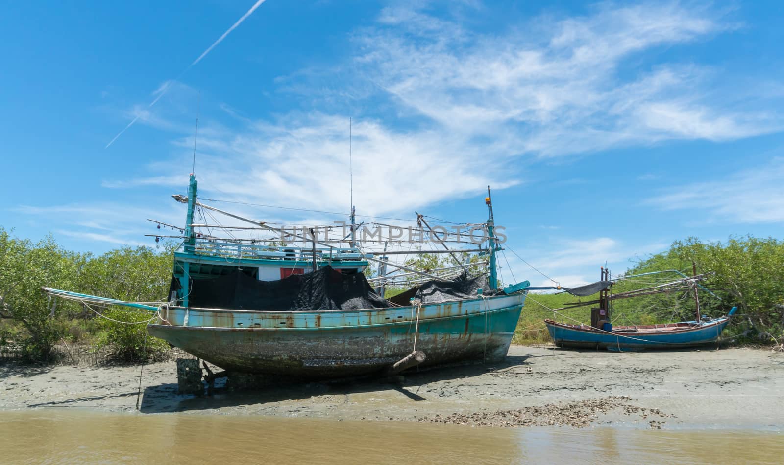 Khao Dang canal boat trip at Prachuap Khiri Khan Thailand. Boat or fishing boat with blue sky and cloud and green tree and water. Landscape or scenery summer concept for boat trip