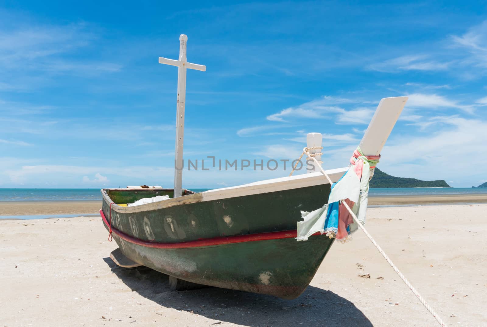 Fishing boat or fisherman boat or ship on Sam Roi Yod bech Prachuap Khiri Khan Thailand with blue sky and cloud and blue sea and mountain or hill. Landscape or scenery for summer season concept