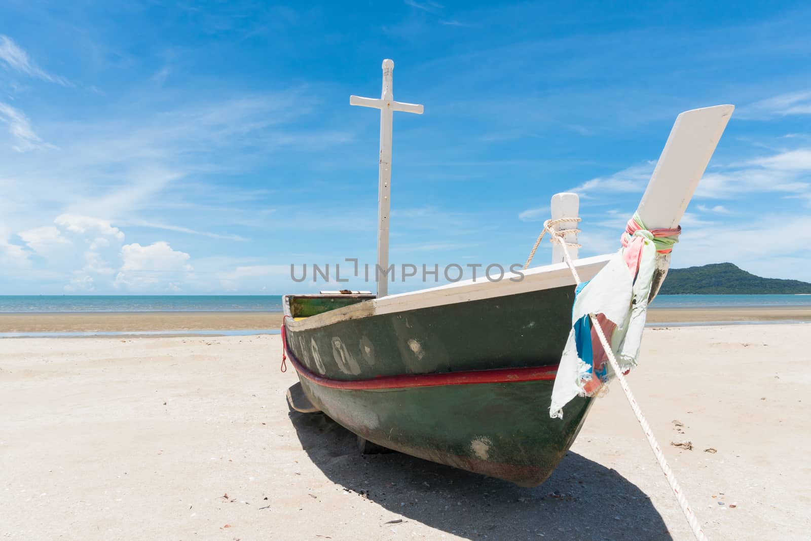 Fishing boat or fisherman boat or ship on Sam Roi Yod bech Prachuap Khiri Khan Thailand with blue sky and cloud and blue sea and mountain or hill. Landscape or scenery for summer season concept