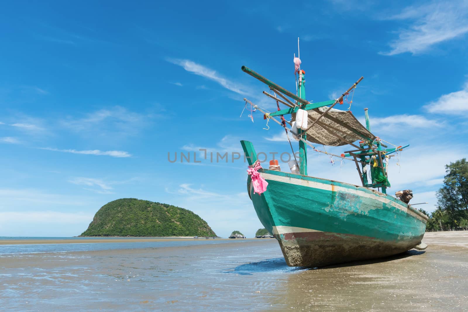 Green Fishing Boat or Fisherman Boat or Ship and blue sky and mountain or hill at Sam Roi Yod Beach Prachuap Khiri Khan Thailand. Landscape 
or scenery for summer season concept