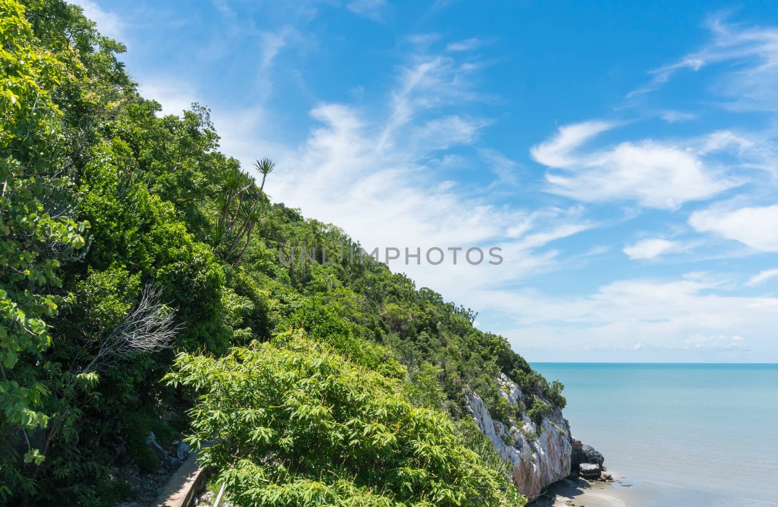 Green Rock or Stone Mountain or Hill and blue sky and walking way at Laem Sala Prachuap Khiri Khan Thailand. Landscape or scenery summer 
season concept