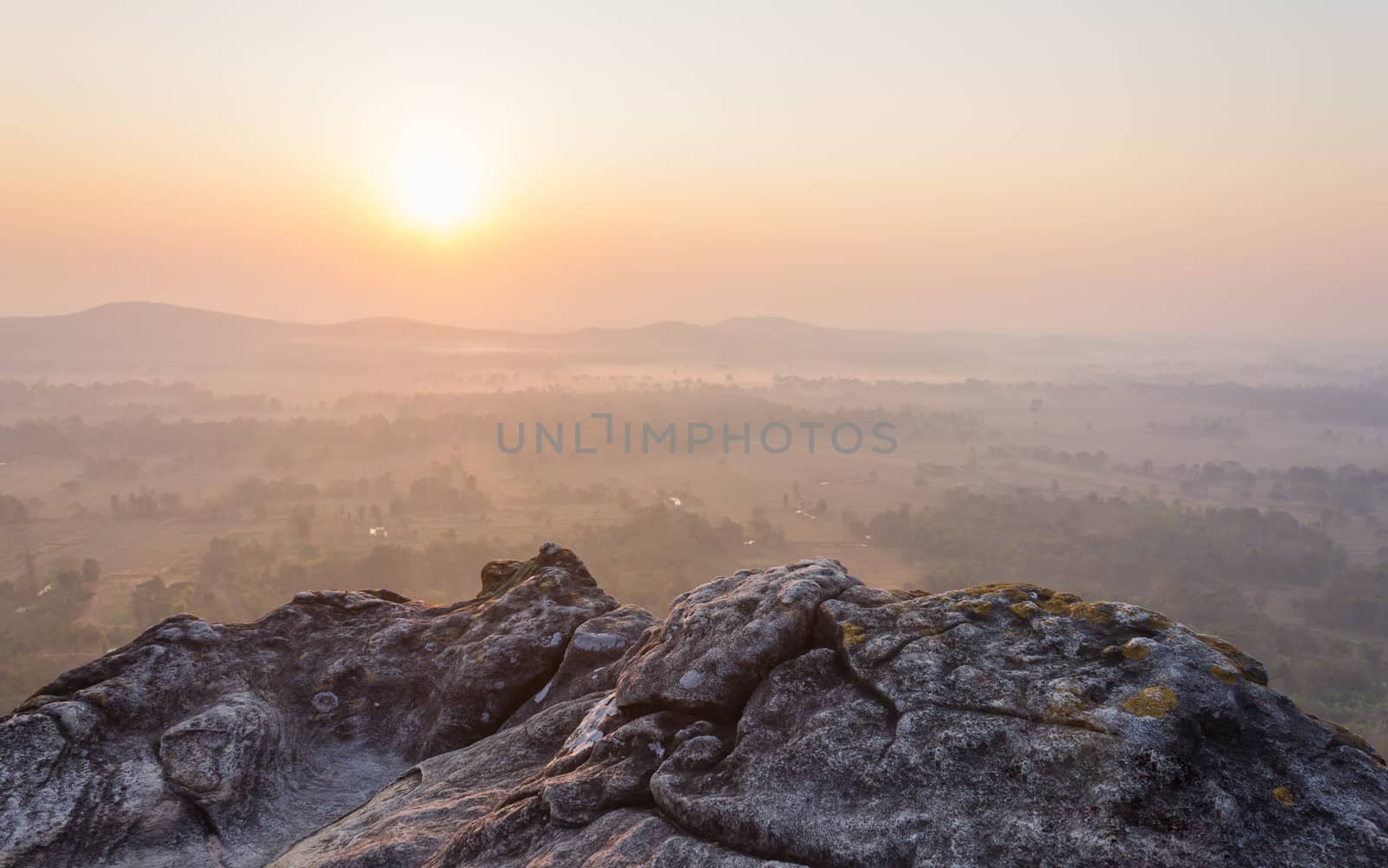 Left Sunrise at Pha Hua Rue Phayao Attractions Thailand Travel. Natural stone or rock mountain with sunrise sky and mist at Phayao northern Thailand travel