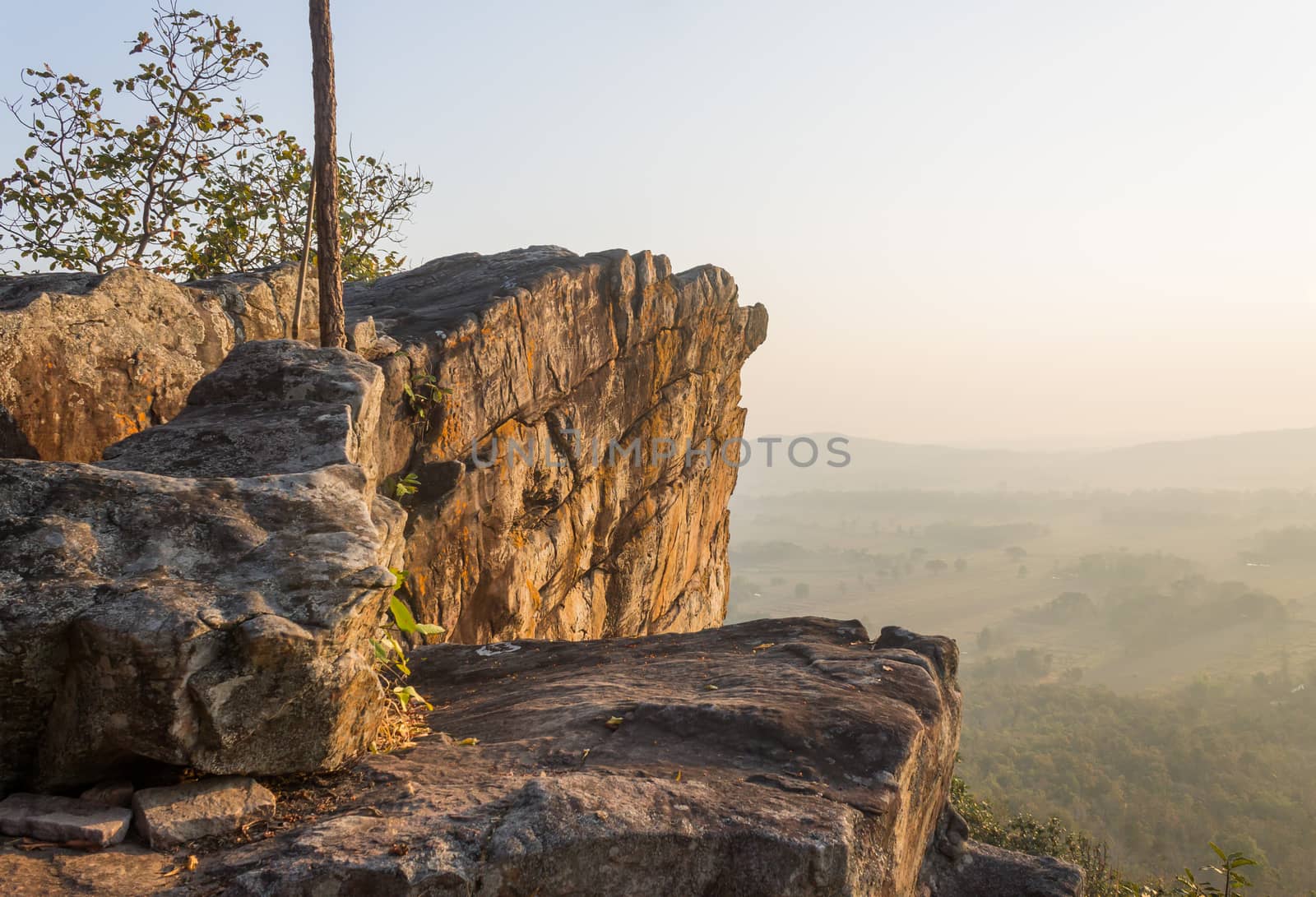 Pha Hua Rue Rock Cliff Mountain Hill Phayao Attractions Thailand with Warm Sun Light and Green Tree Landscape Left. Natural stone or rock mountain hill at Phayao northern Thailand travel