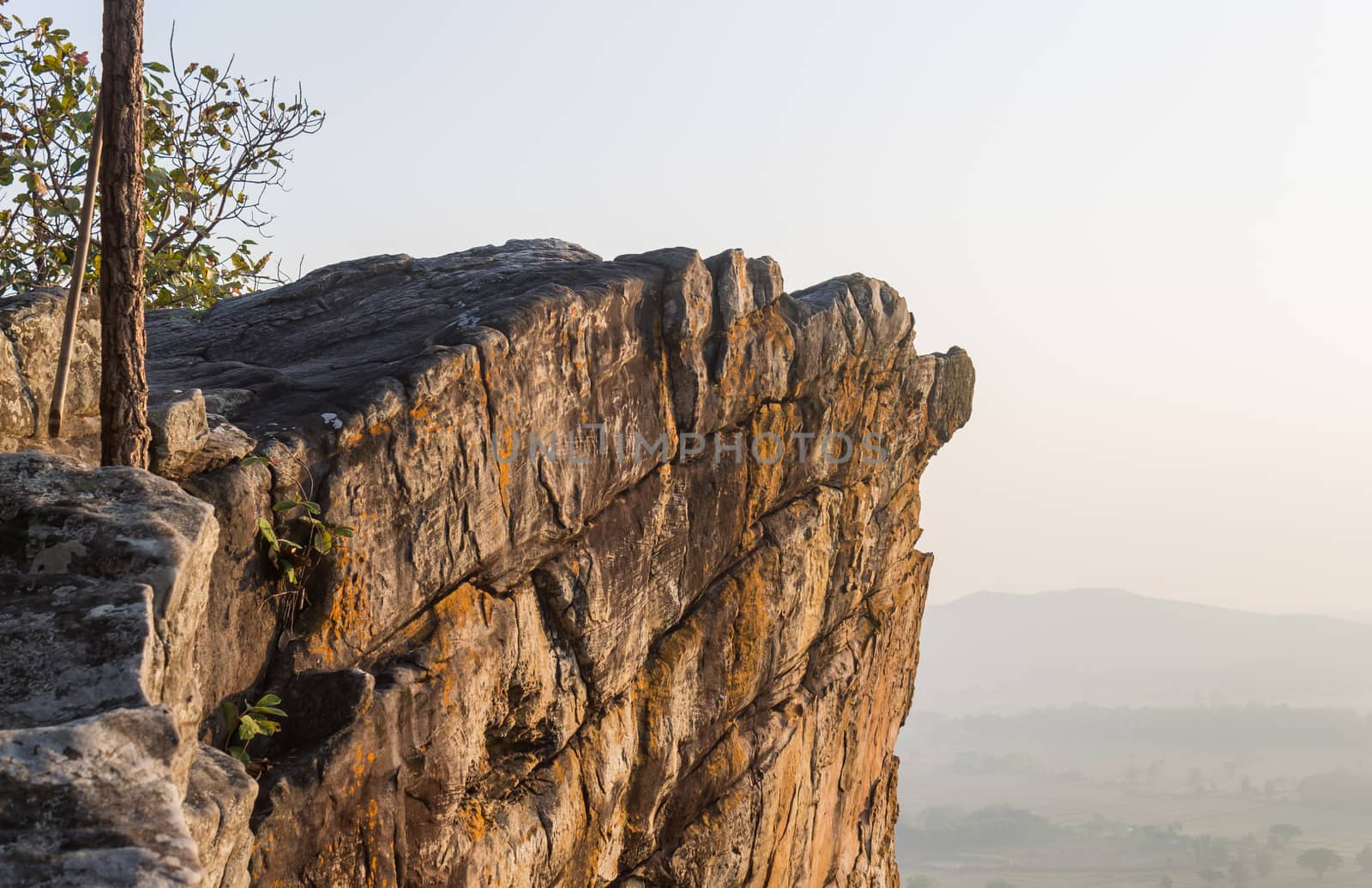 Pha Hua Rue Rock Cliff Mountain Hill Phayao Attractions Thailand with Warm Sun Light and Green Tree Landscape Left Zoom. Natural stone or rock mountain hill at Phayao northern Thailand travel