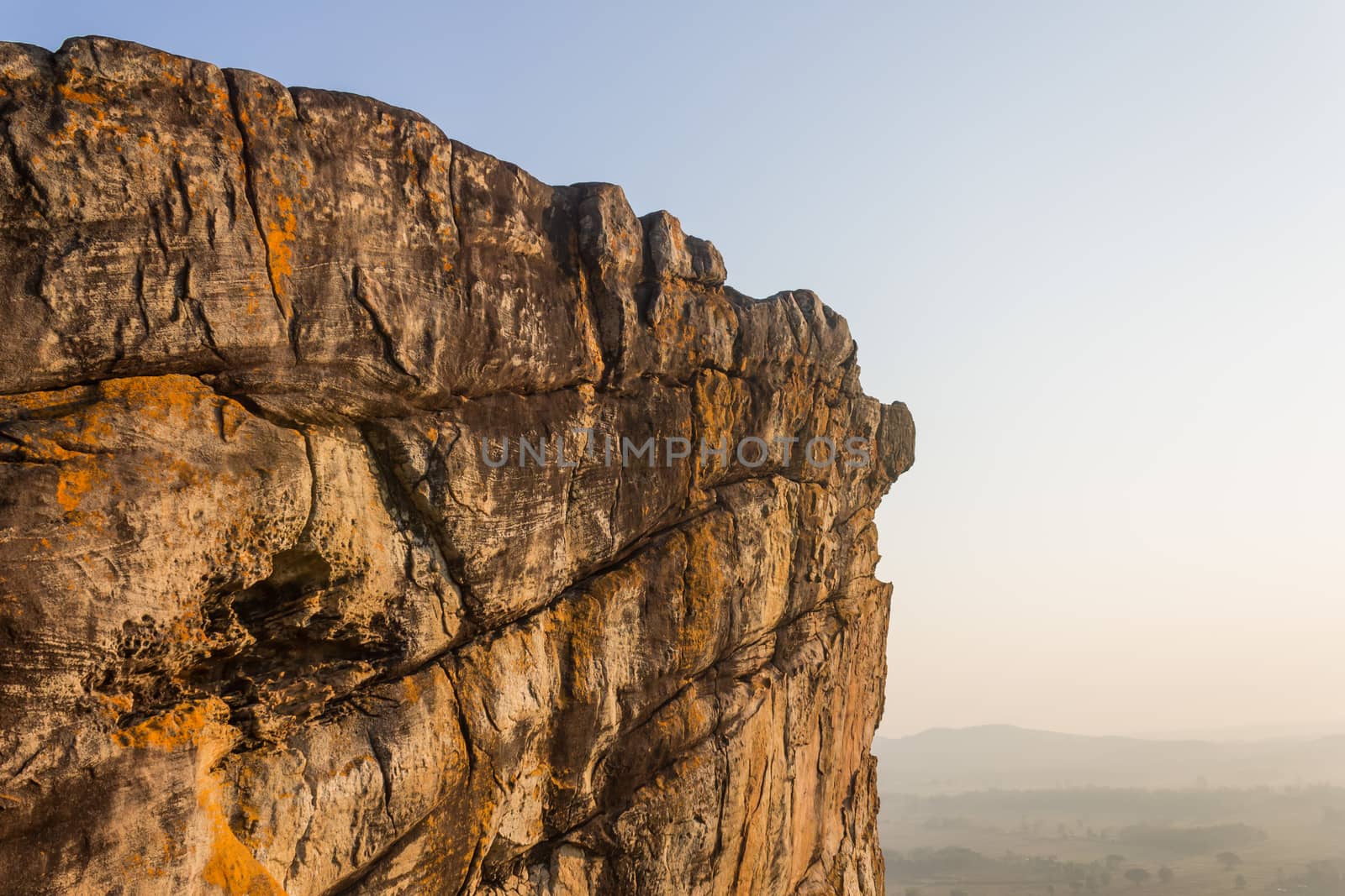 Pha Hua Rue Rock Cliff Mountain Hill Phayao Attractions Thailand with Warm Sun Light and Green Tree Landscape Side Zoom. Natural stone or rock mountain hill at Phayao northern Thailand travel