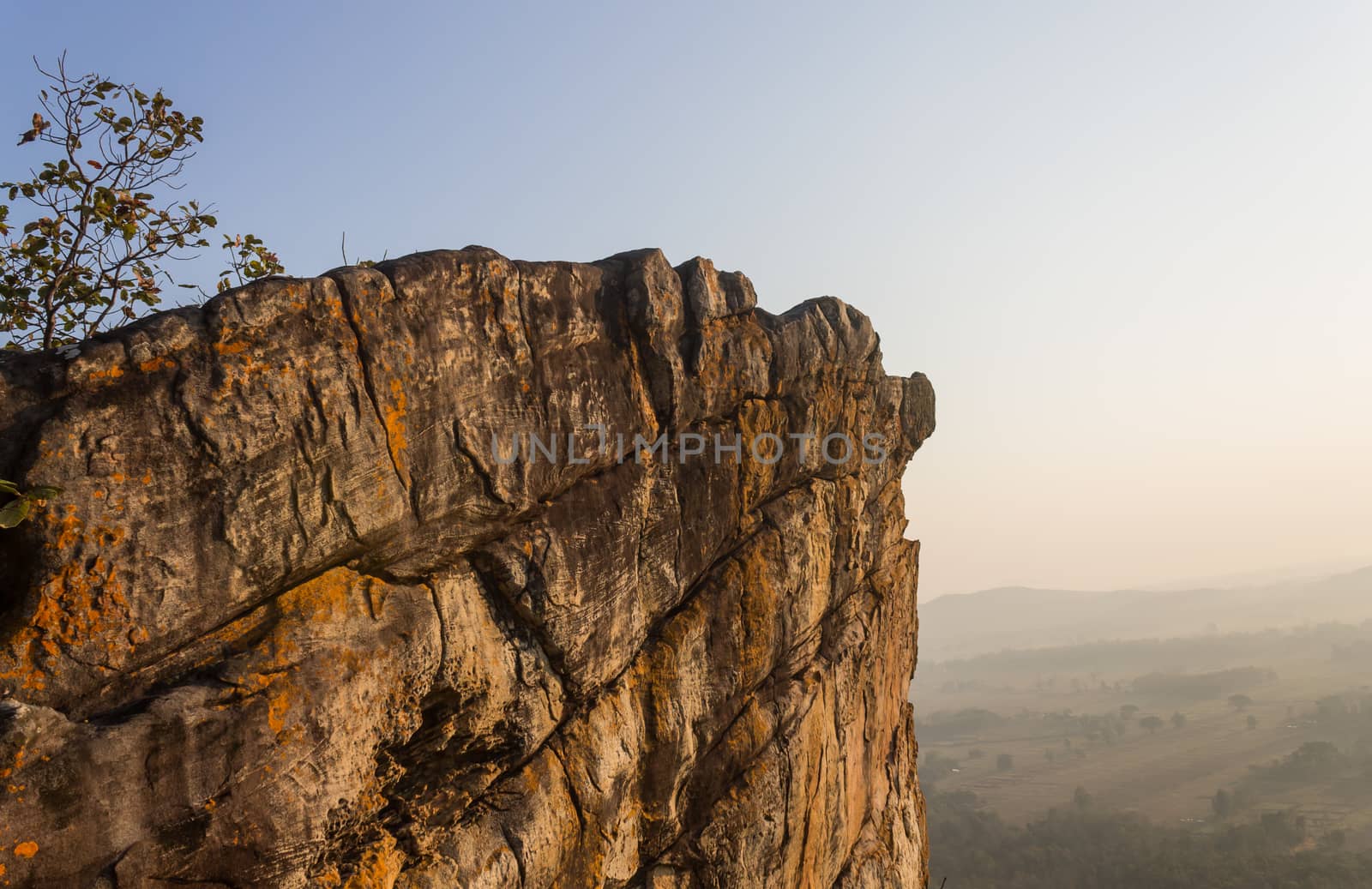 Pha Hua Rue Rock Cliff Mountain Hill Phayao Attractions Thailand with Warm Sun Light and Green Tree Landscape Side. Natural stone or rock mountain hill at Phayao northern Thailand travel