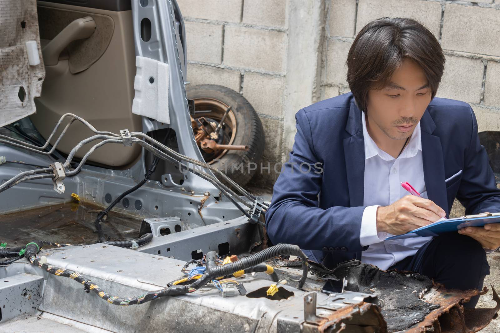 Asian Insurance Agent or Insurance Agency Inspecting Car and Wri by steafpong