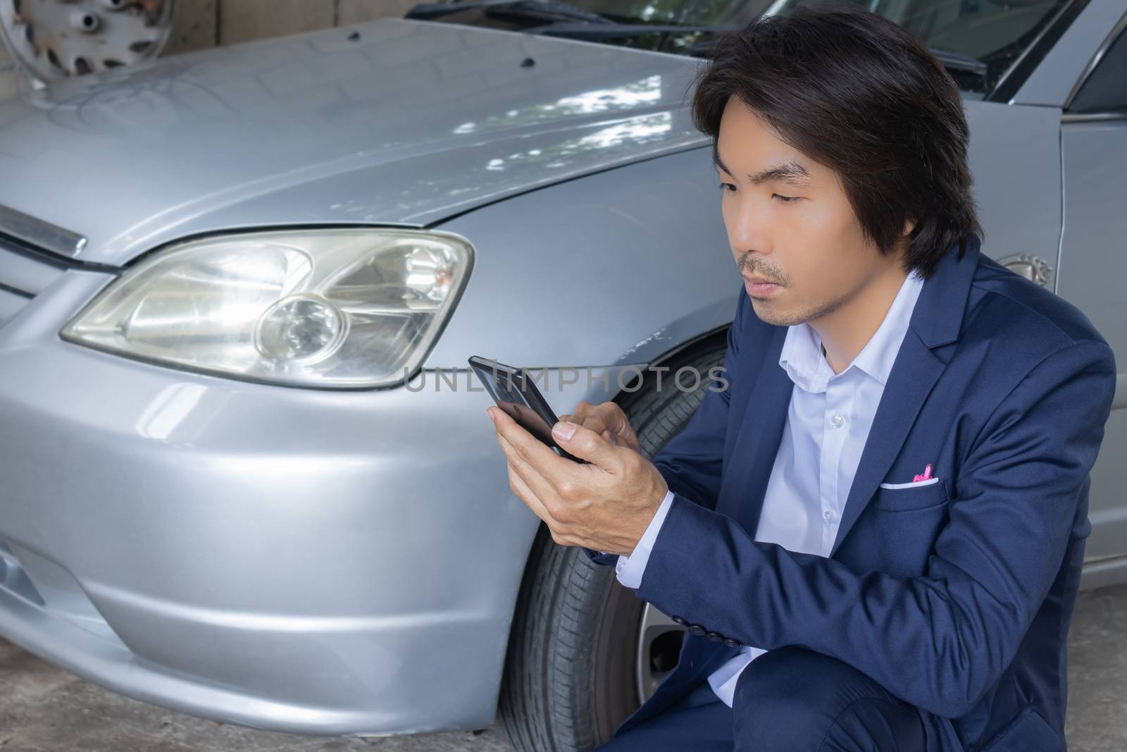Asian Insurance Agent or Insurance Agency in Suit See Smartphone and Inspecting Car Crash from Accident for Claim at Outdoor Place on Wide Angle View