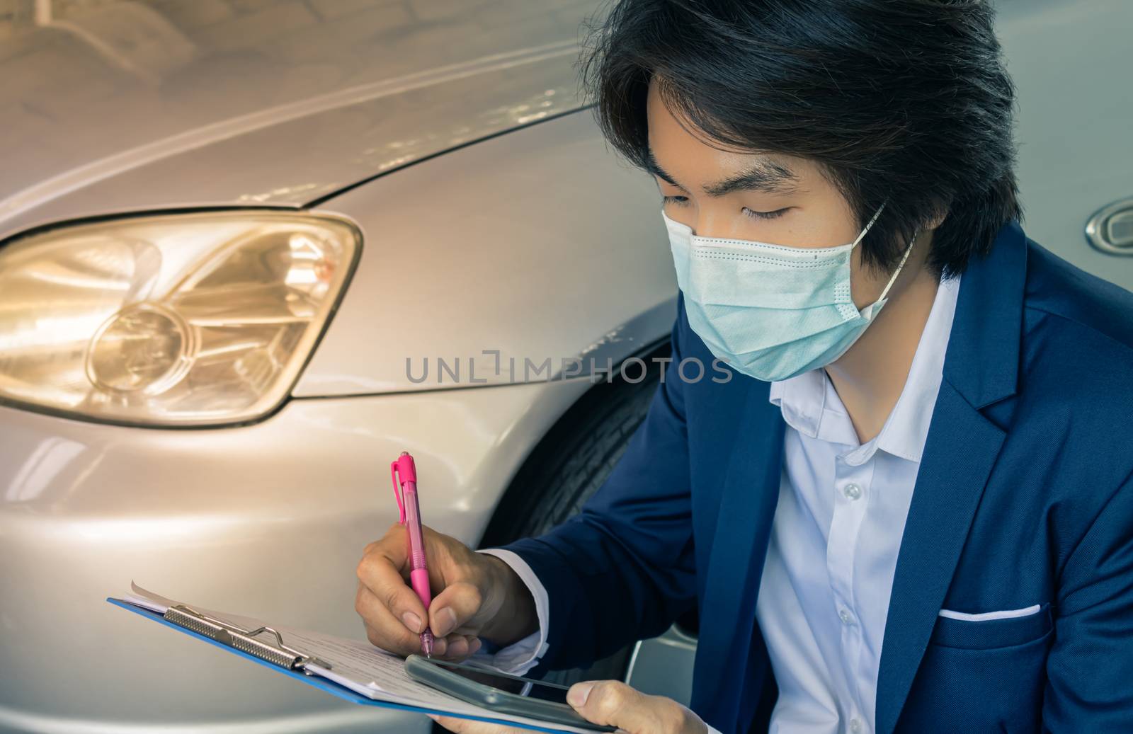 Asian Insurance Agent or Insurance Agency in Suit Wear Mask Writing Car Crash Report and Inspecting Car from Accident for Claim at Outdoor Place in Zoom View in Vintage Tone
