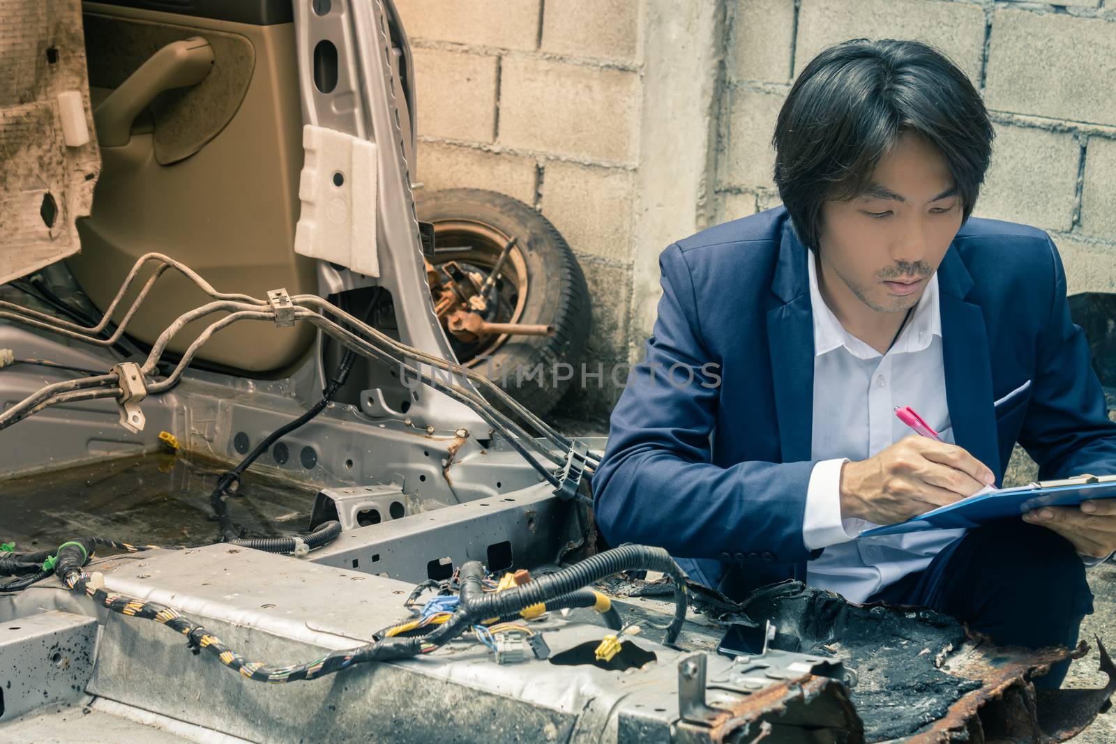 Asian Insurance Agent or Insurance Agency Inspecting Car and Wri by steafpong