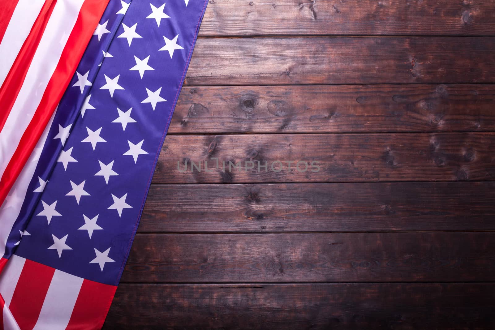 The American Flag Laying on a Wooden Background by IxMaster