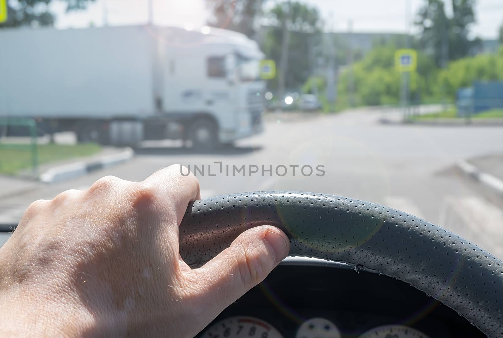 view of the driver hand at the wheel of a car at a road by jk3030