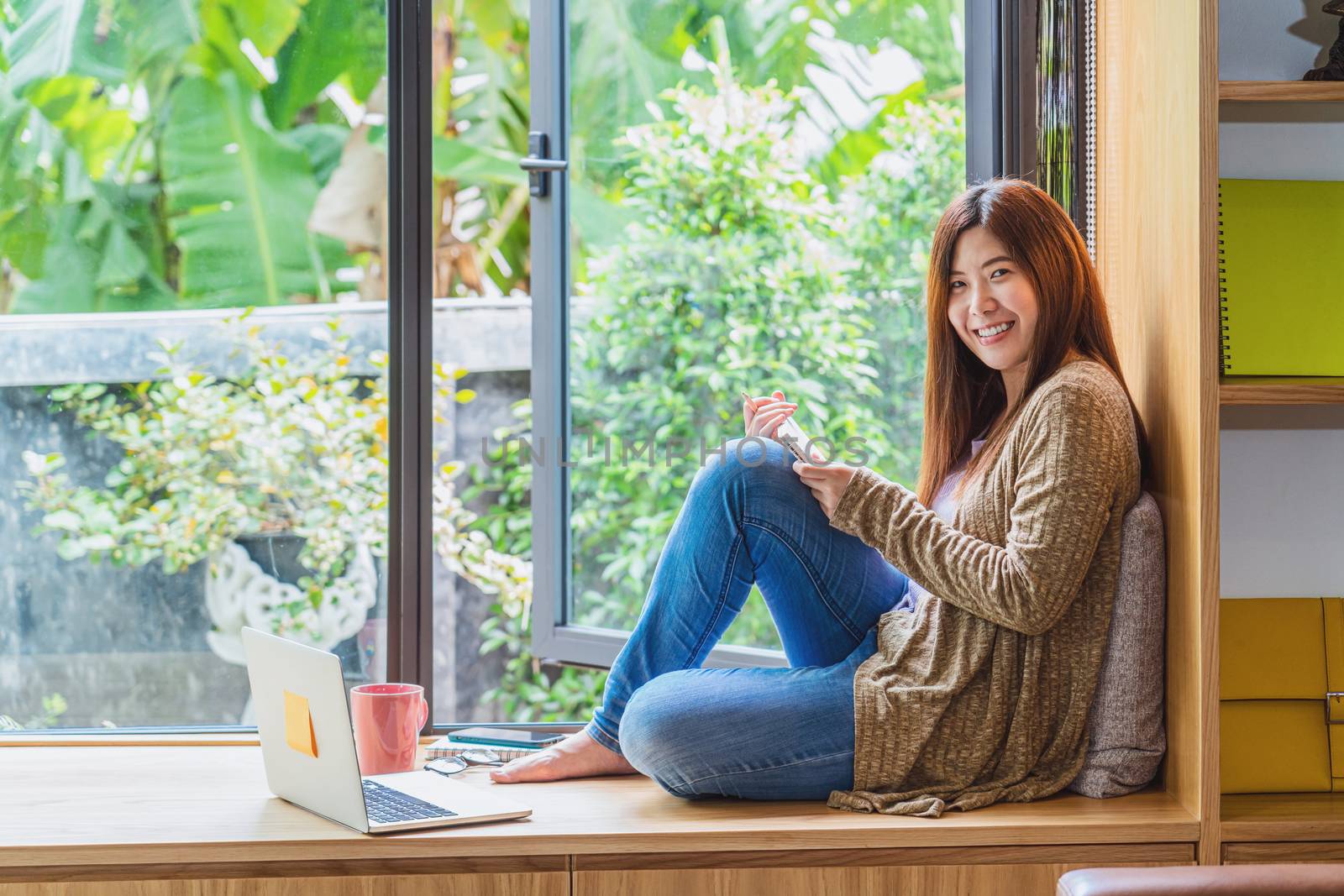 Portrait Asian business woman working and using technology lapto by Tzido