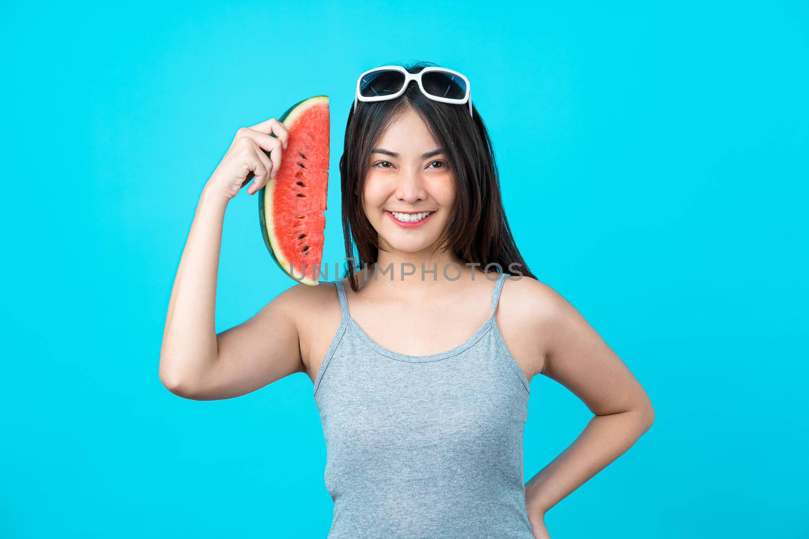 Attractive Asian young woman wearing summer vest and holding the by Tzido