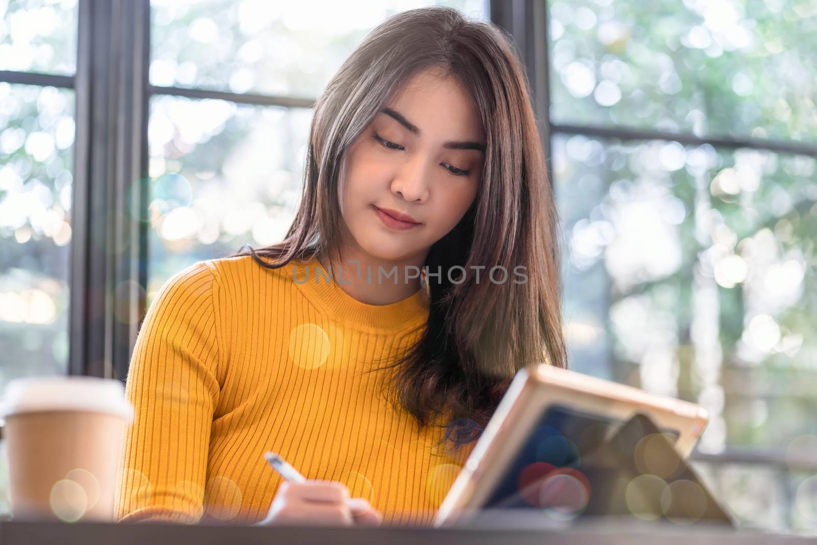 Asian young female working and using technology laptop in modern by Tzido