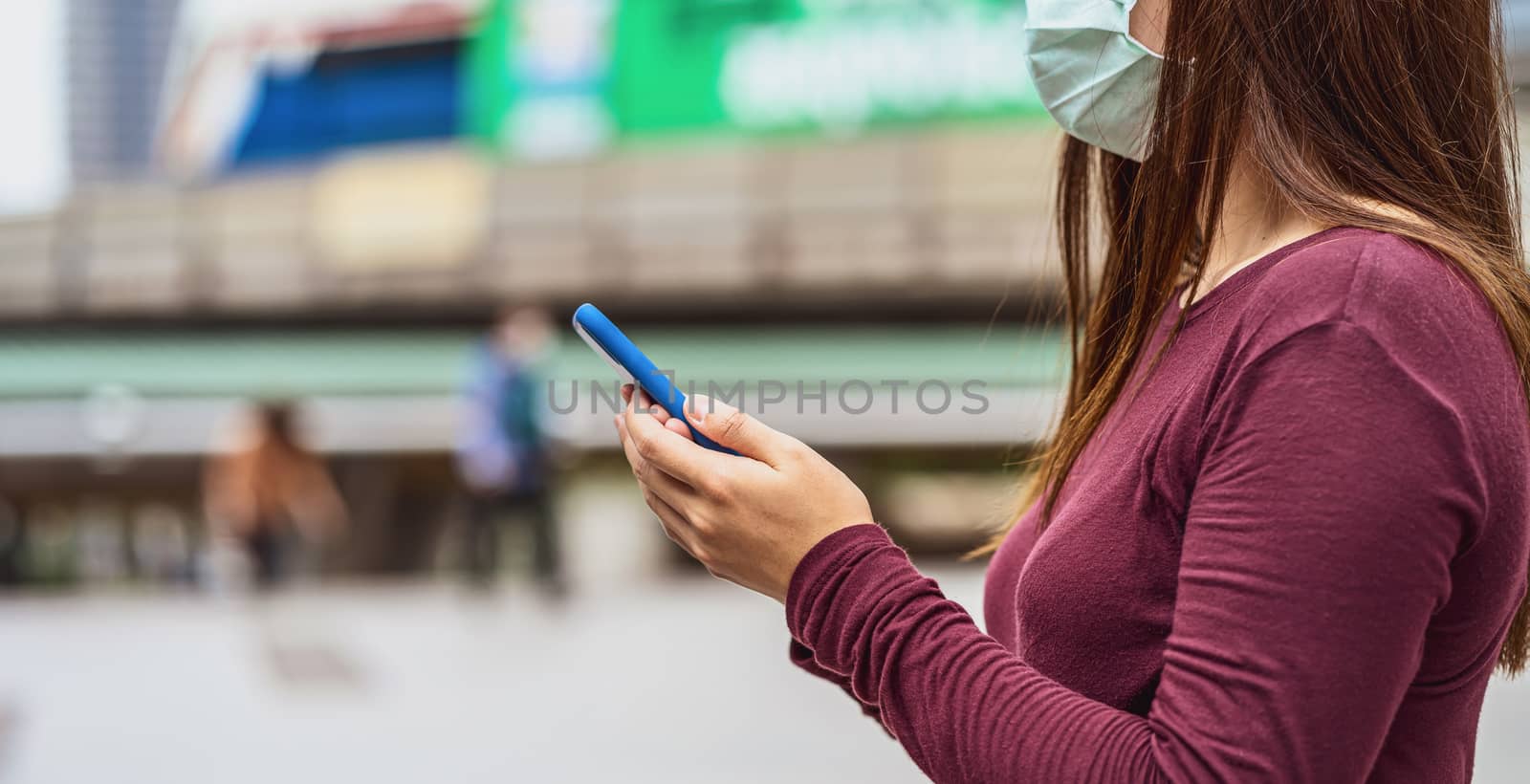 Closeup Asian woman hand using smart mobile phone with safety me by Tzido