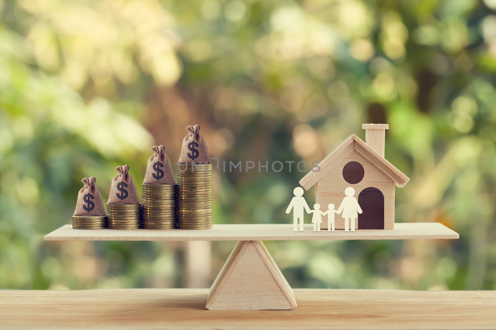 Property investment and house mortgage concept: Wooden home, Family member and US money bags on rows of rising coins on wood balance scale. depicts family financial management for a residence. by setila